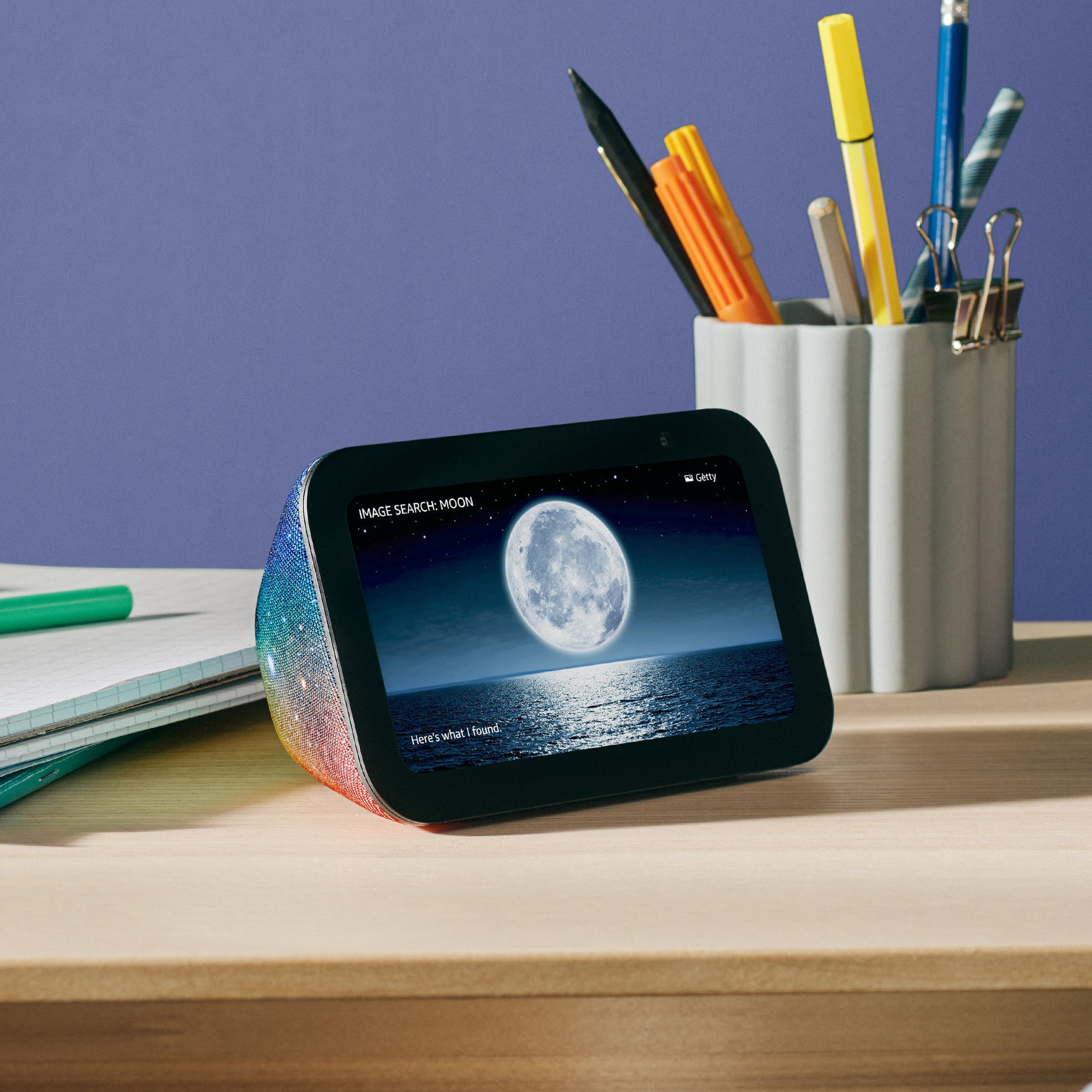 A galaxy-themed version of the third-gen Echo Show 5 Kids resting on a desk.