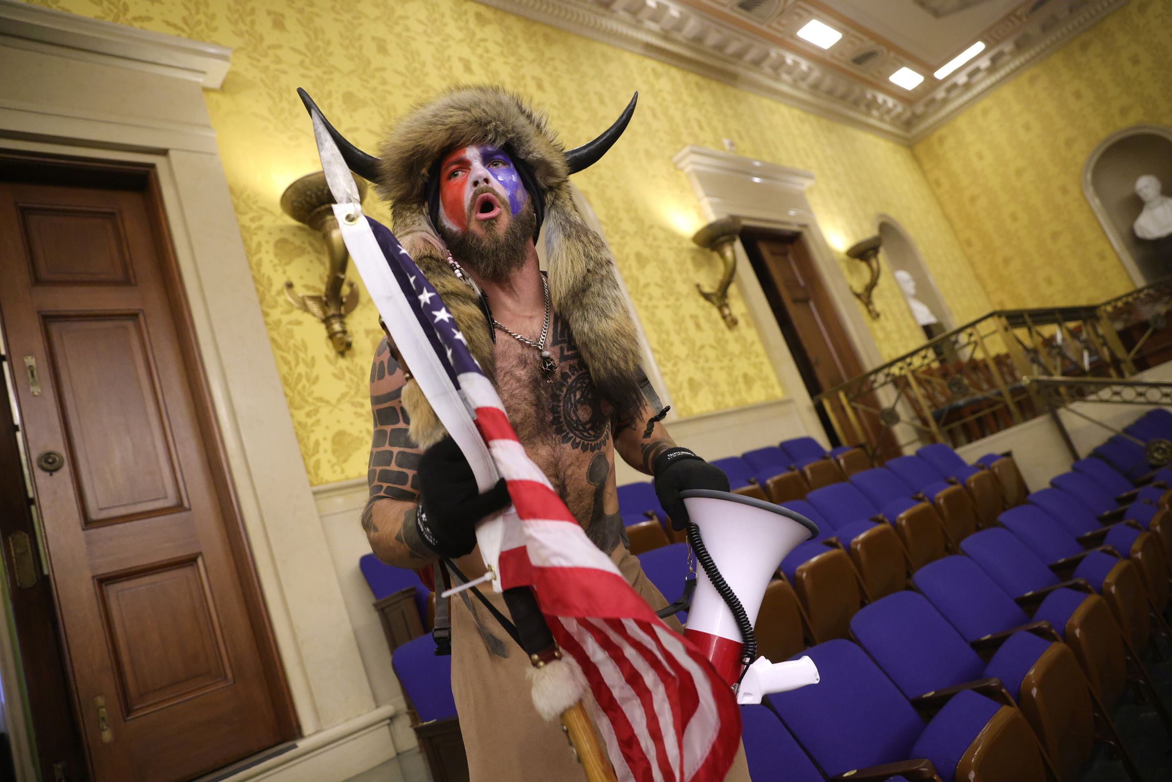 A protester screams “Freedom” inside the Senate Chamber after the US Capitol was breached by a mob during a joint session of Congress.