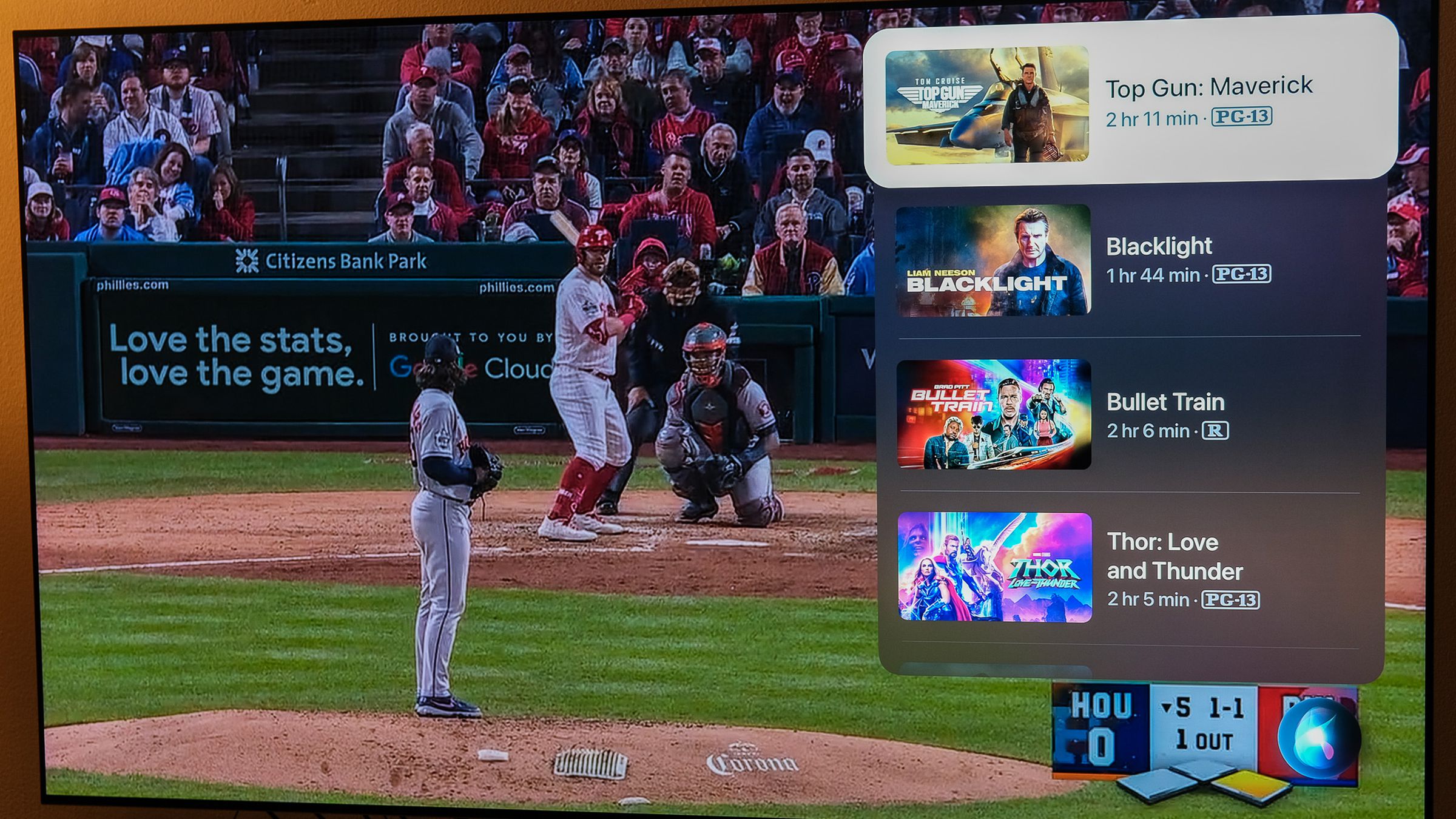 A photo of Siri showing movie results over a World Series game.