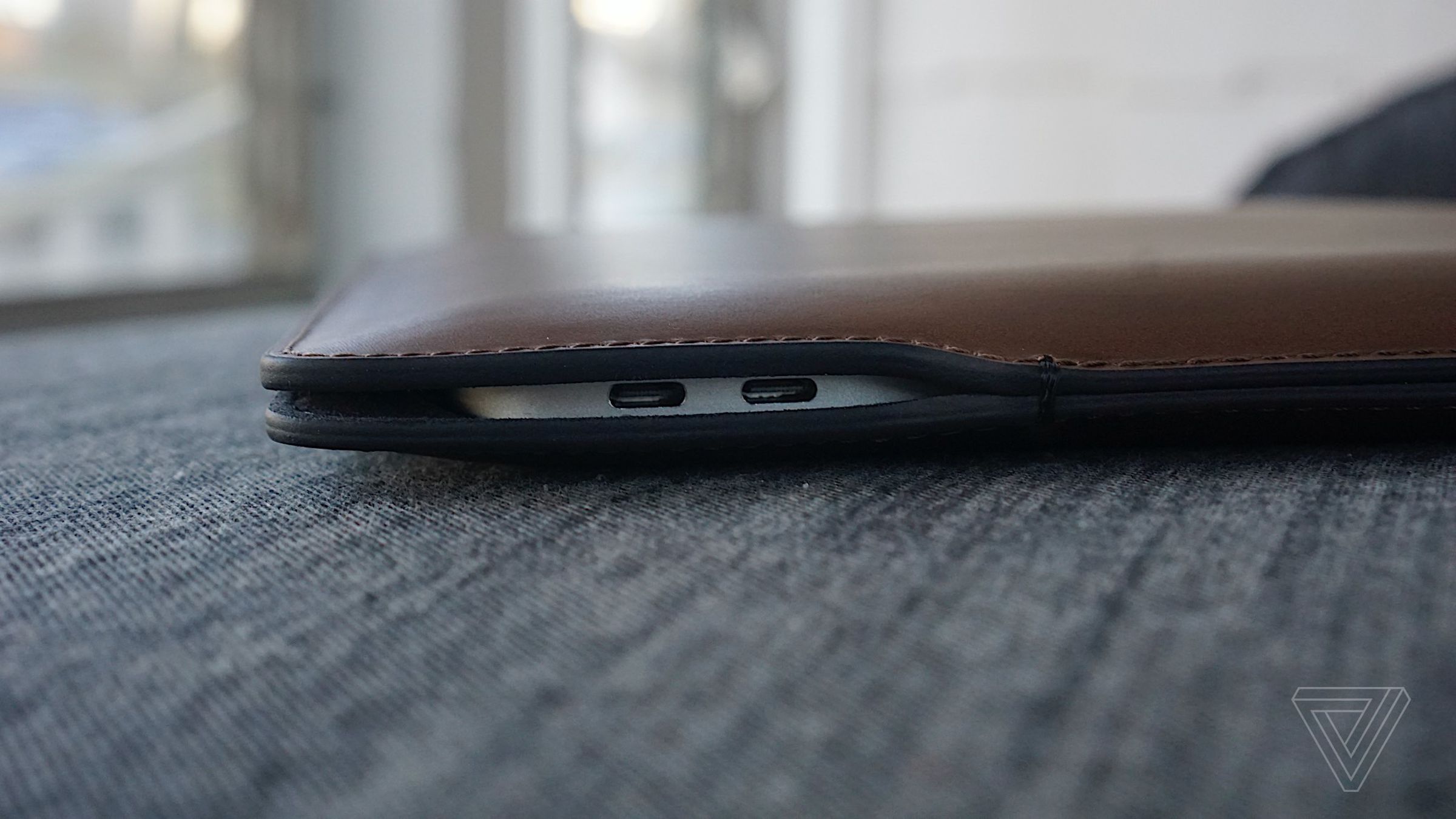 The USB-C charging cutout on the side of the Nomad MacBook Sleeve.