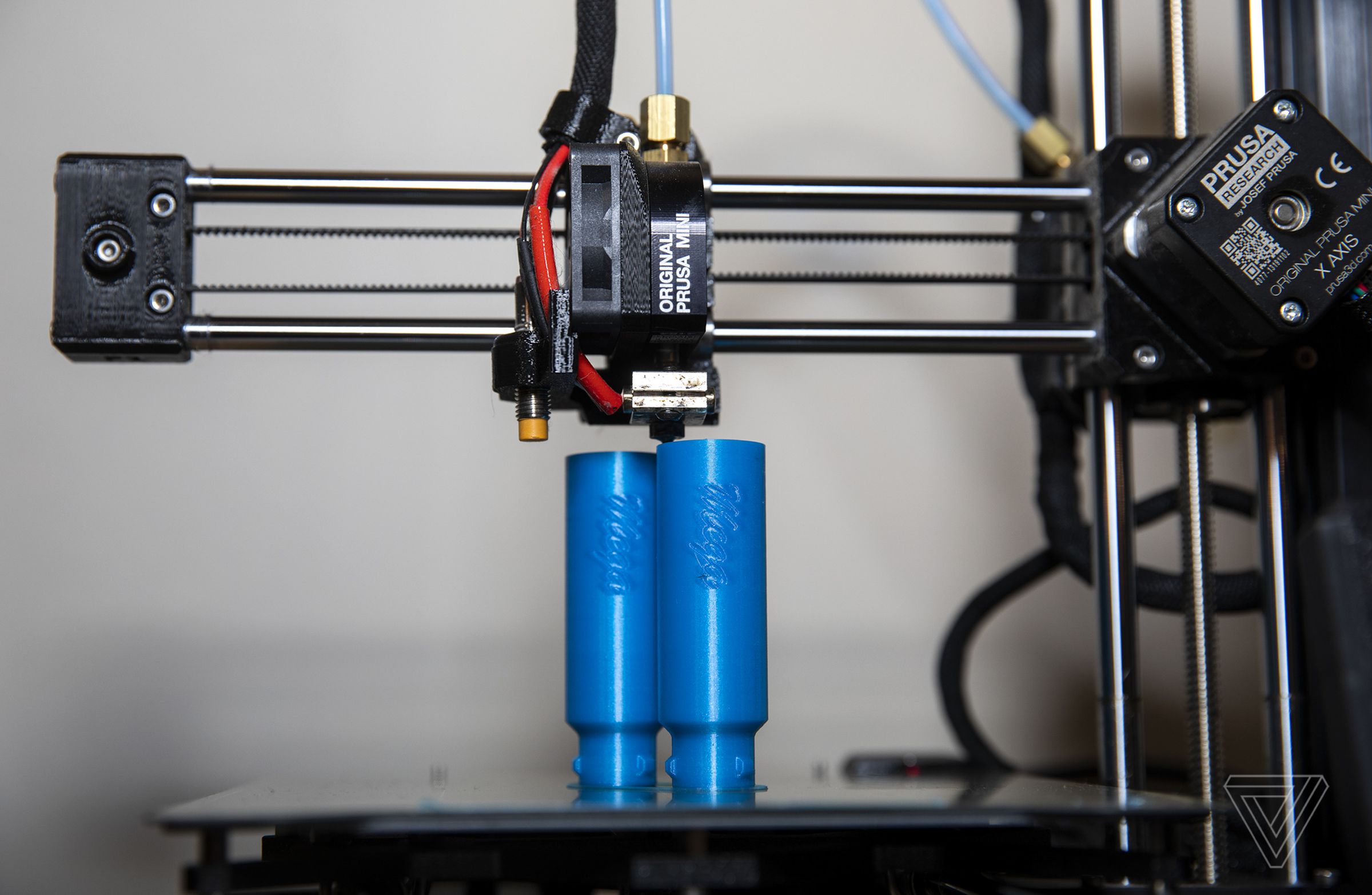 A 3D printer produces original parts at Out of Darts. Out of Darts runs 97 3D printers to produce their original blasters and modification parts.