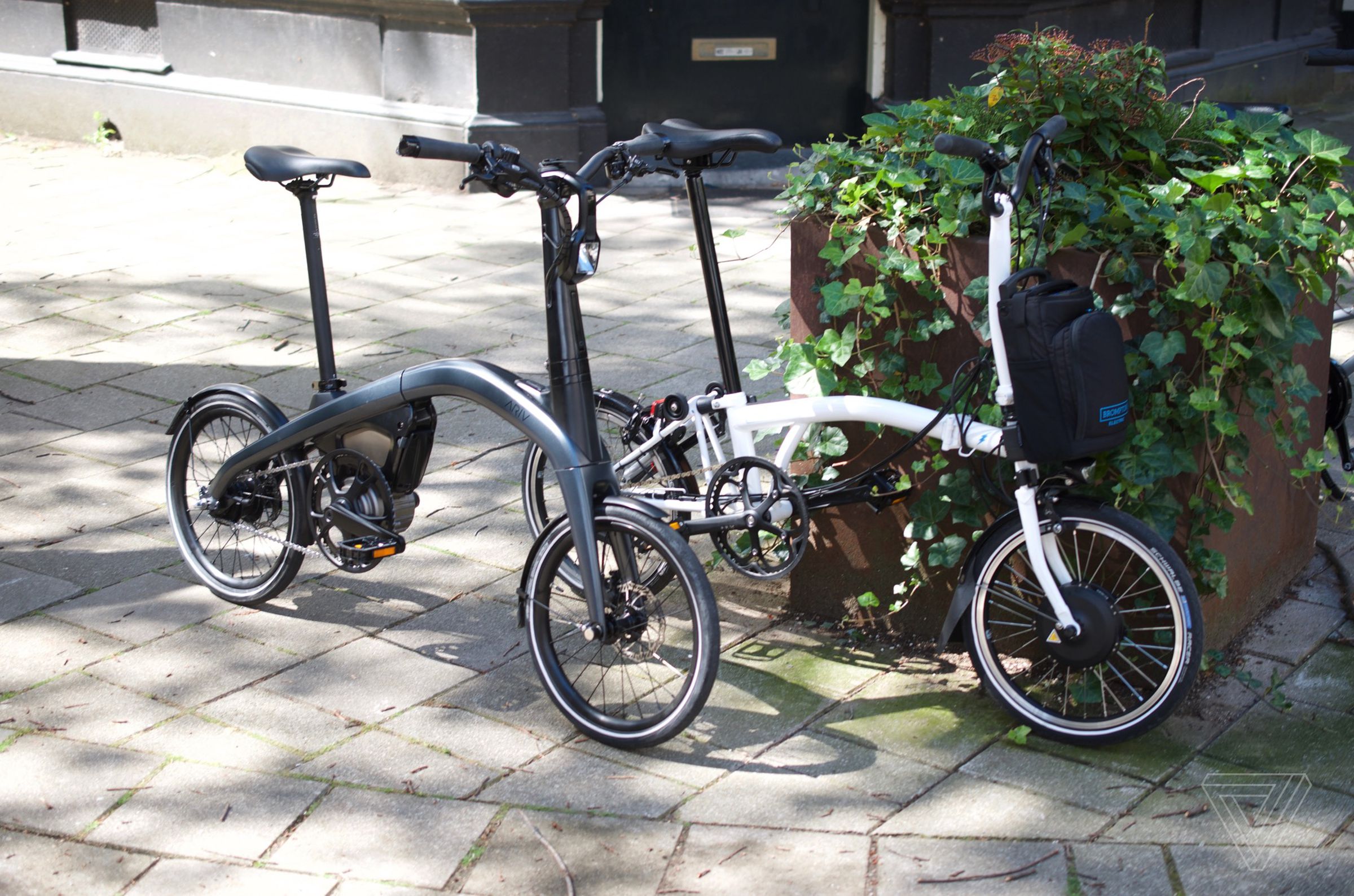 Ariv Merge (black) and Brompton (white) e-bikes.