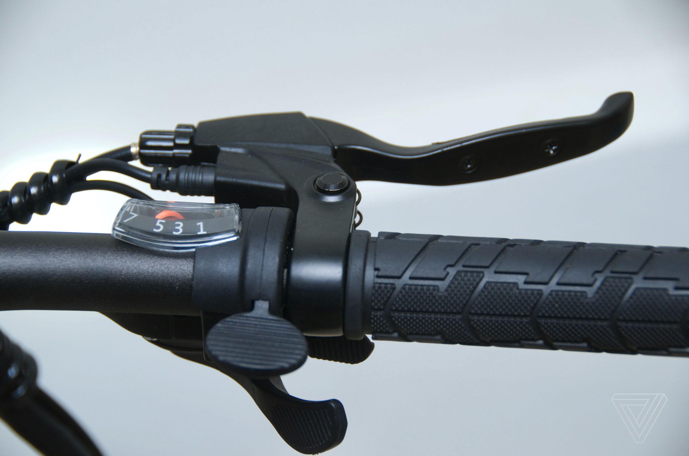 The paddle switch with ridges is the throttle.