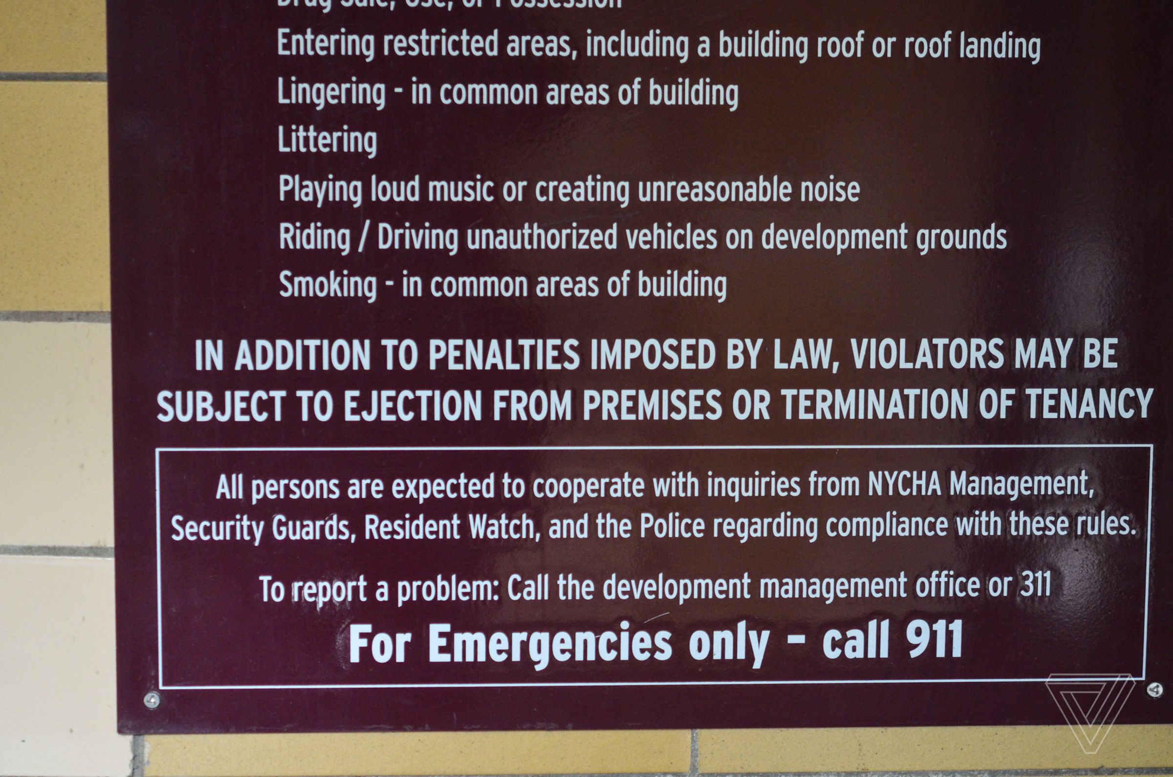A sign inside each building at Queensbridge Houses says residents can’t smoke in common areas — subject to penalties or eviction