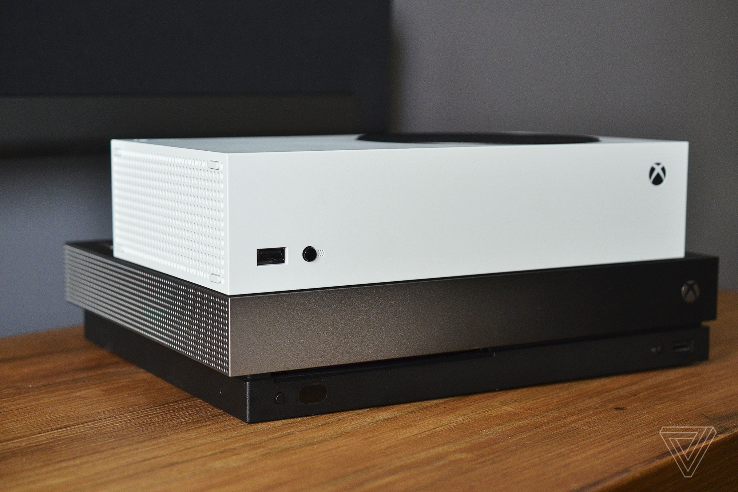 The Xbox Series X on top of an Xbox One X.