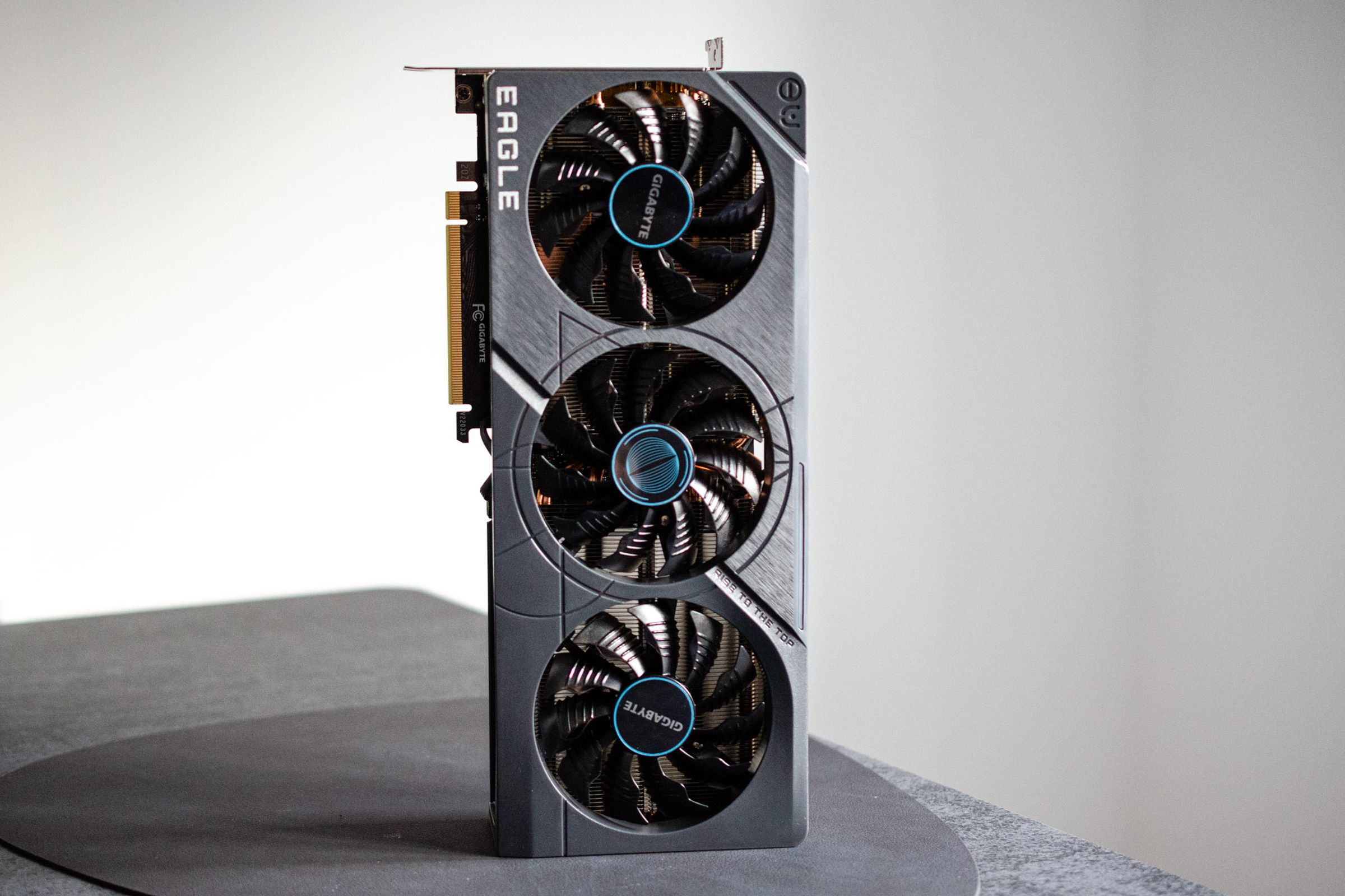 The Gigabyte RTX 4070 Ti standing vertically on a leather mat