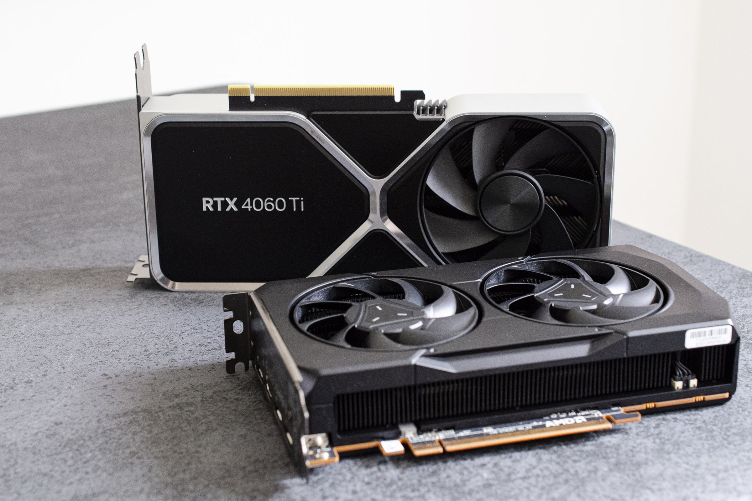 Photo of the RTX 4060 Ti and AMD’s RX 7600 graphics cards on a table