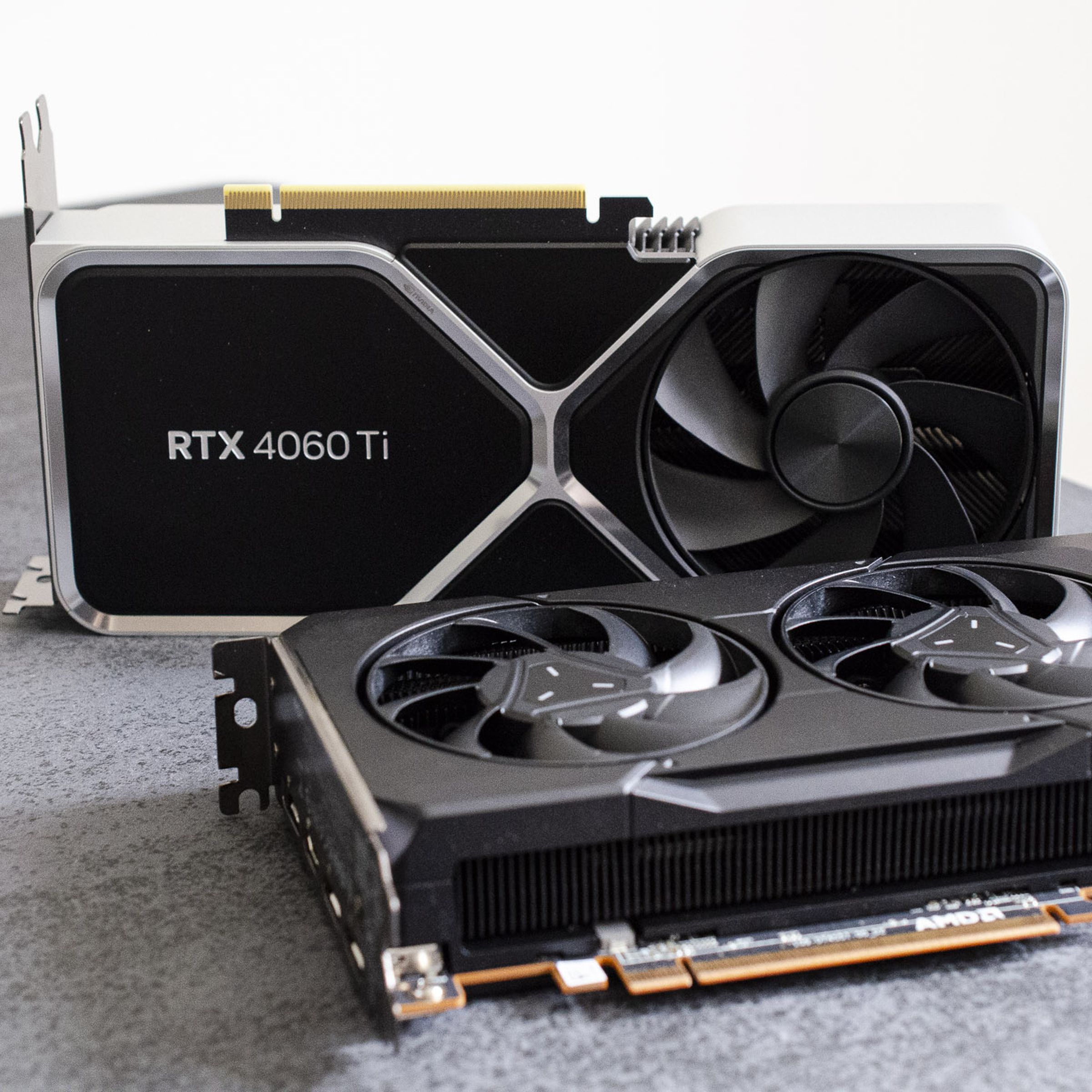 Photo of the RTX 4060 Ti and AMD’s RX 7600 graphics cards on a table