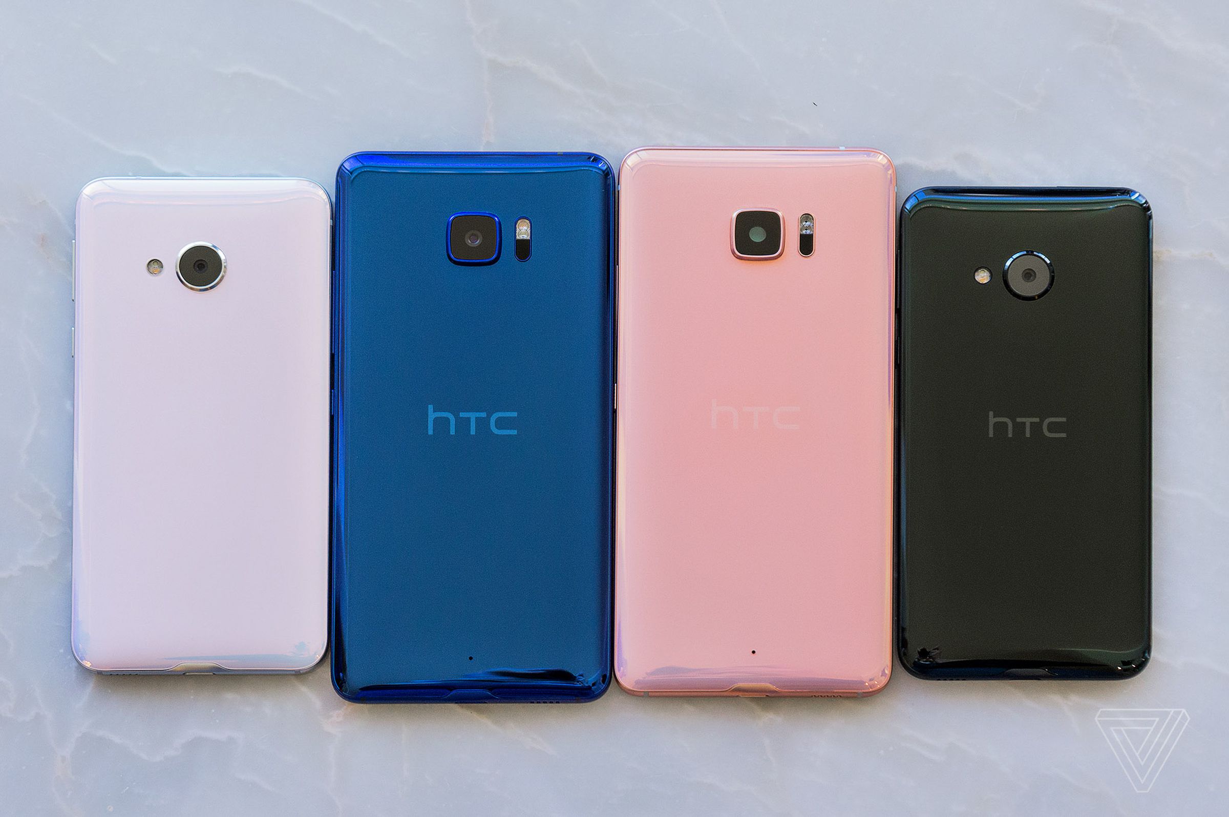 HTC’s U Ultra in blue and pink, bracketed by the smaller U Play in white and black