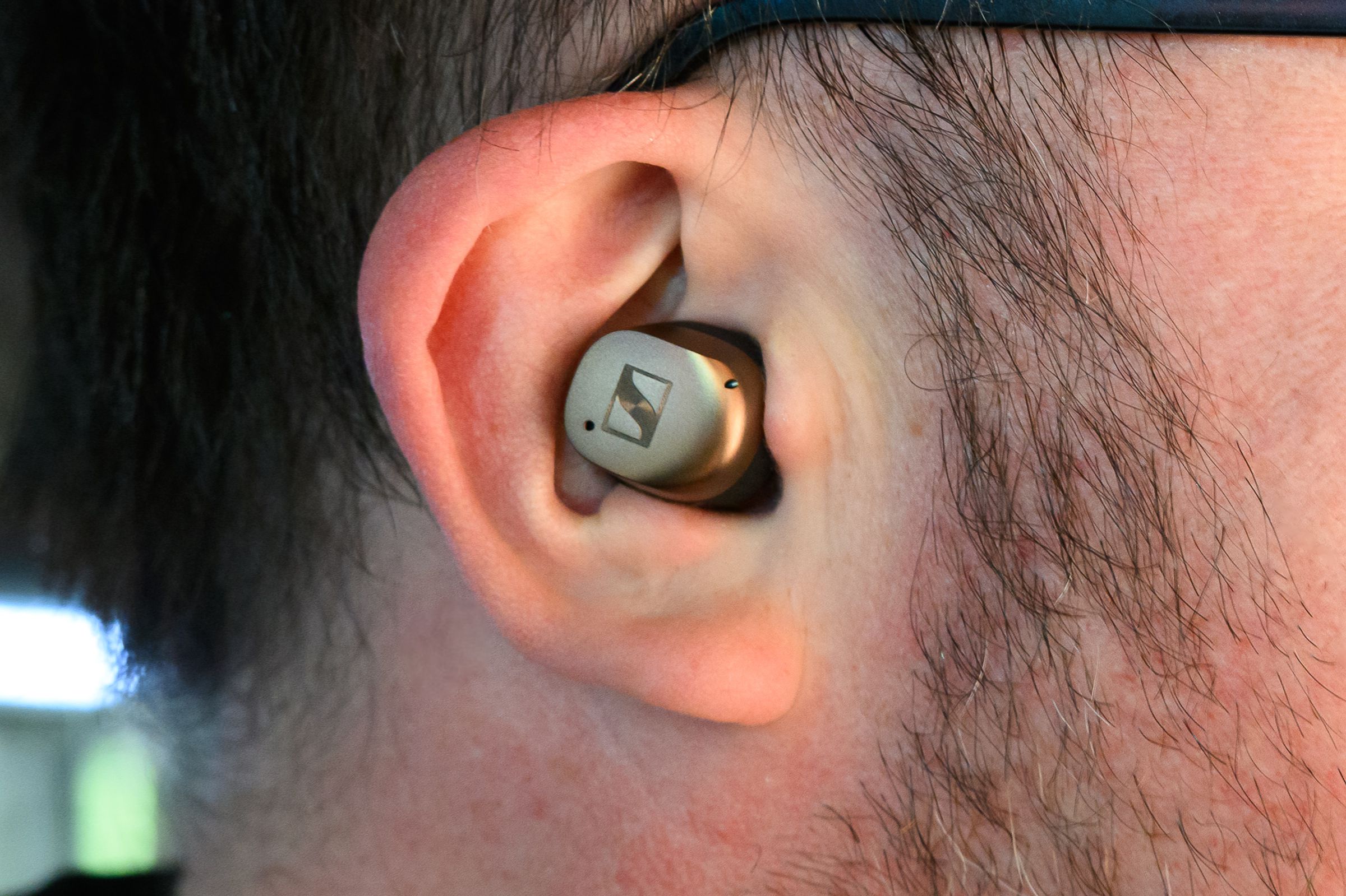 A closeup photo of Sennheiser’s Momentum True Wireless 4 earbuds in a person’s ear.