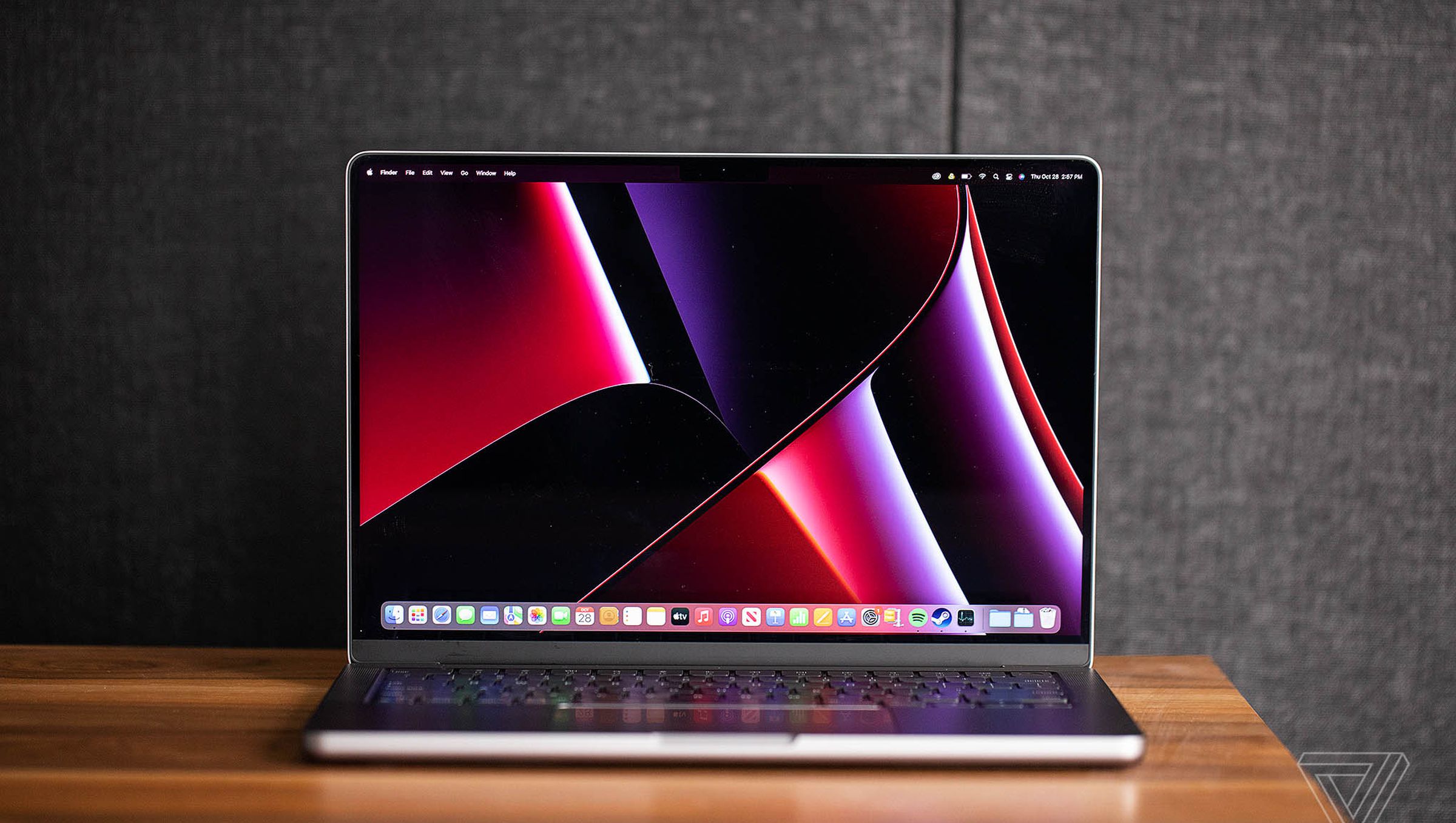 Apple’s 2021 14-inch MacBook Pro sitting turned on and open with its screen facing the camera on a desk.