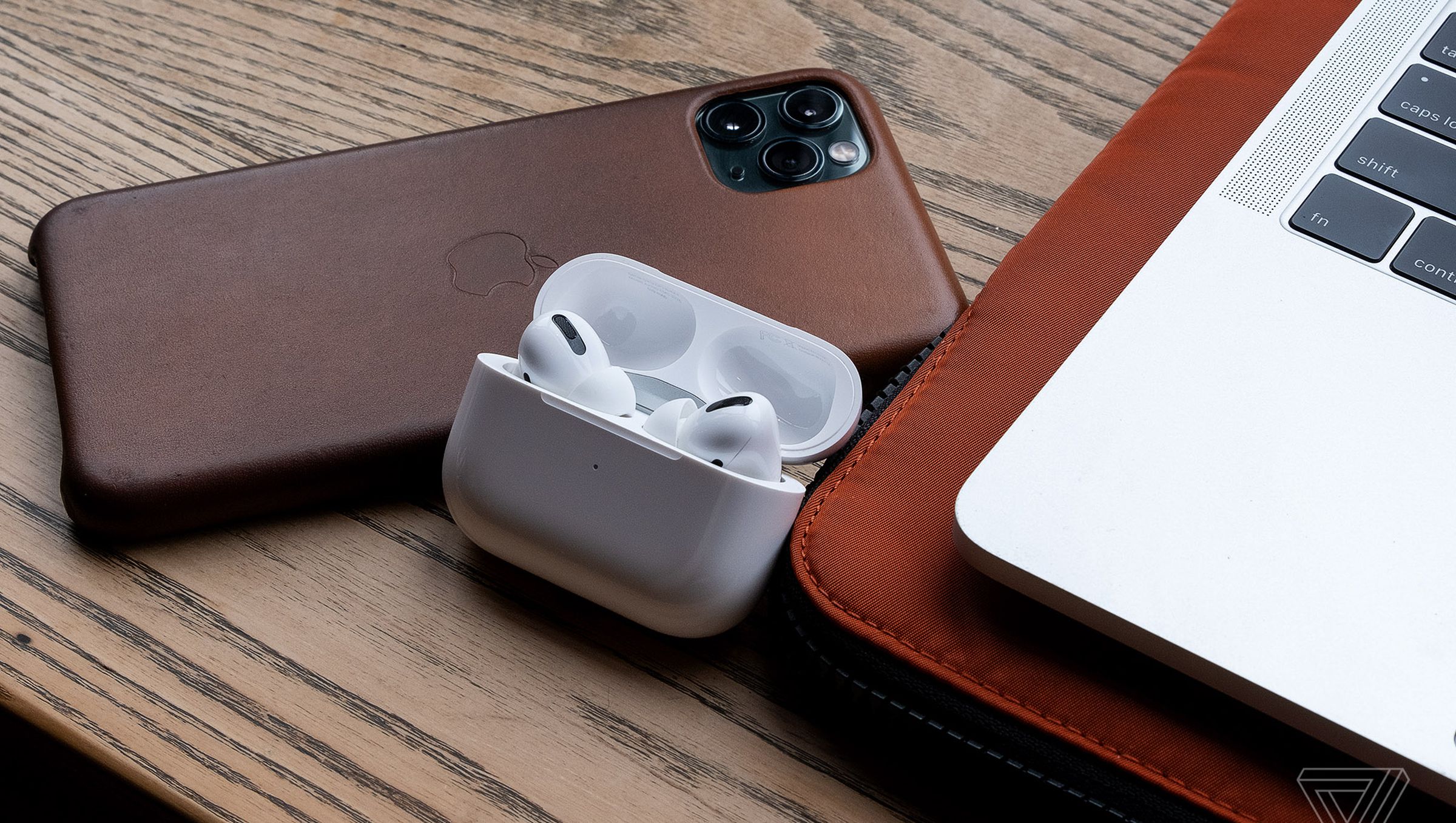 The AirPods Pro, the best wireless earbuds for people using Apple products, pictured next to an iPhone 11 Pro Max and MacBook Pro.