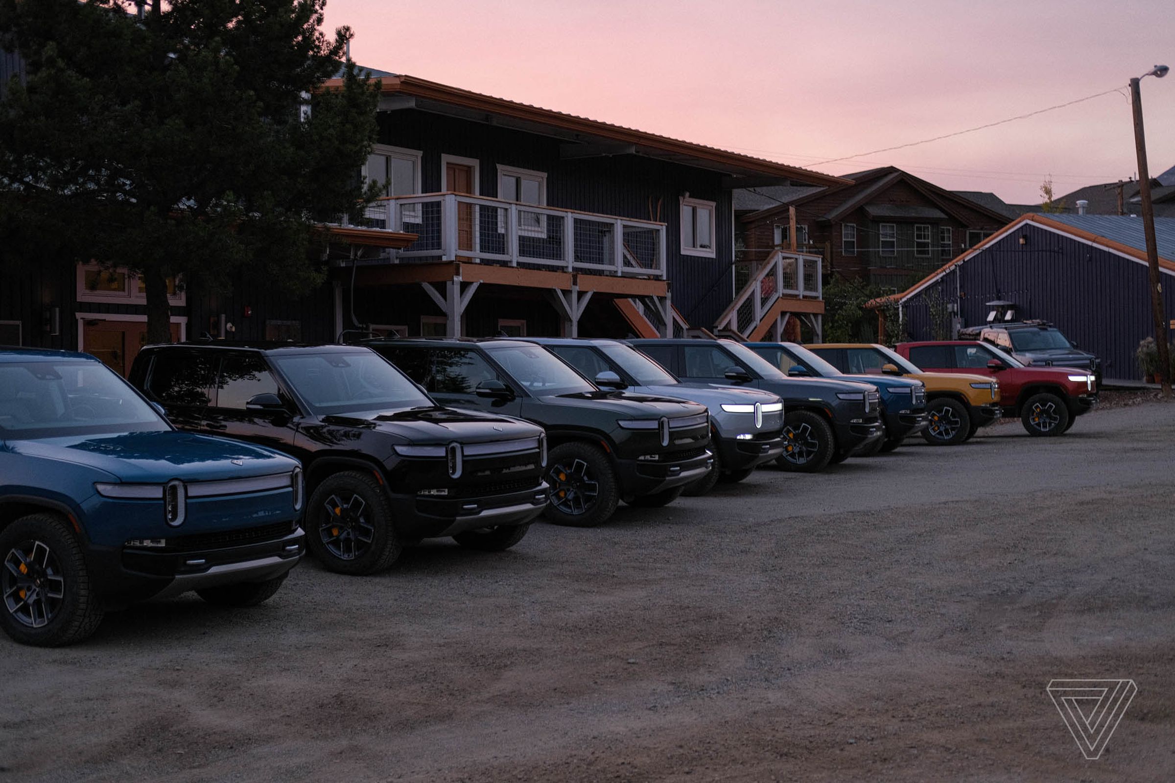 Photo of several Rivian R1Ts parked.