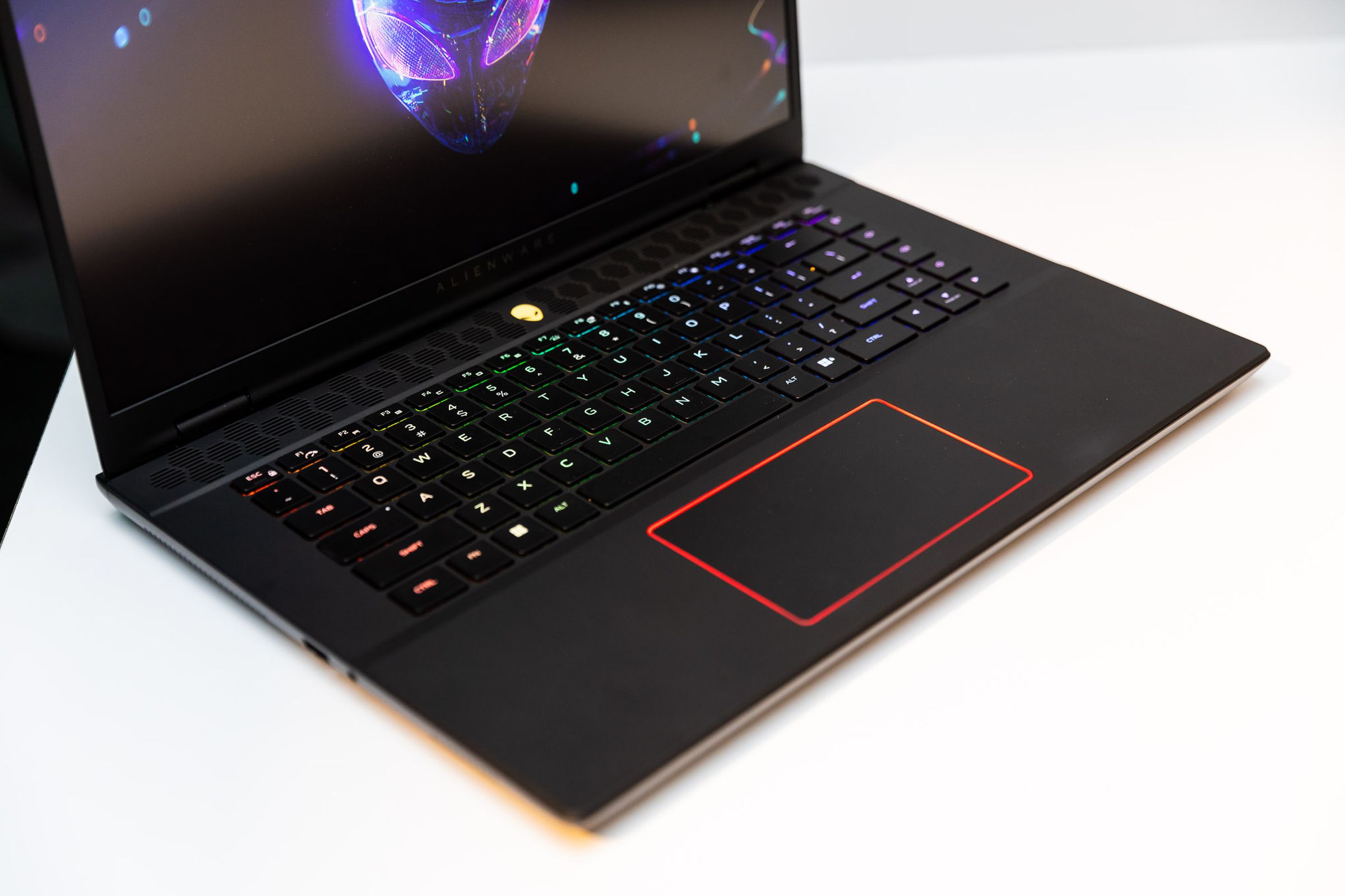A picture of an MSI laptop with a red LED lining the touchpad.