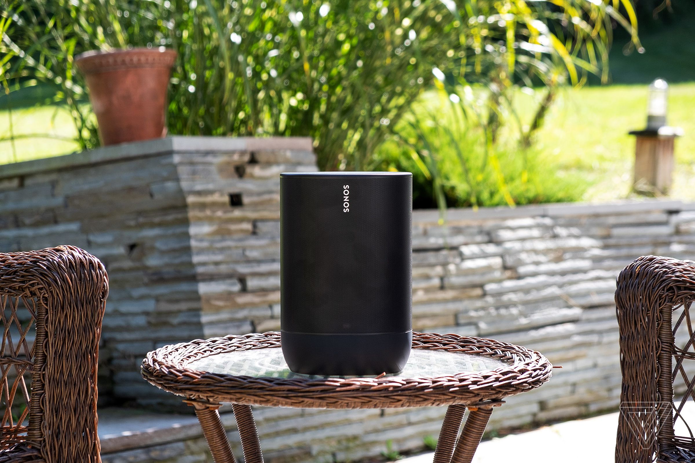 A photo of the Sonos Move speaker on a backyard patio.