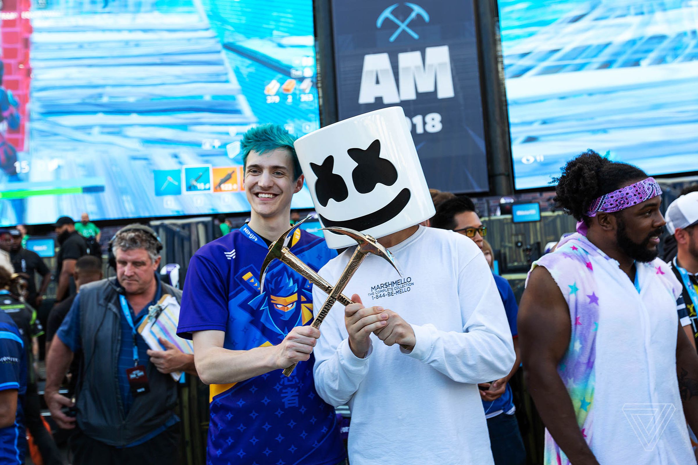 Twitch streamer Tyler “Ninja” Blevins and electronic music artist Marshmellow pose for photographs after winning the final round of Epic Games’ Fortnite Pro-Am competition. 