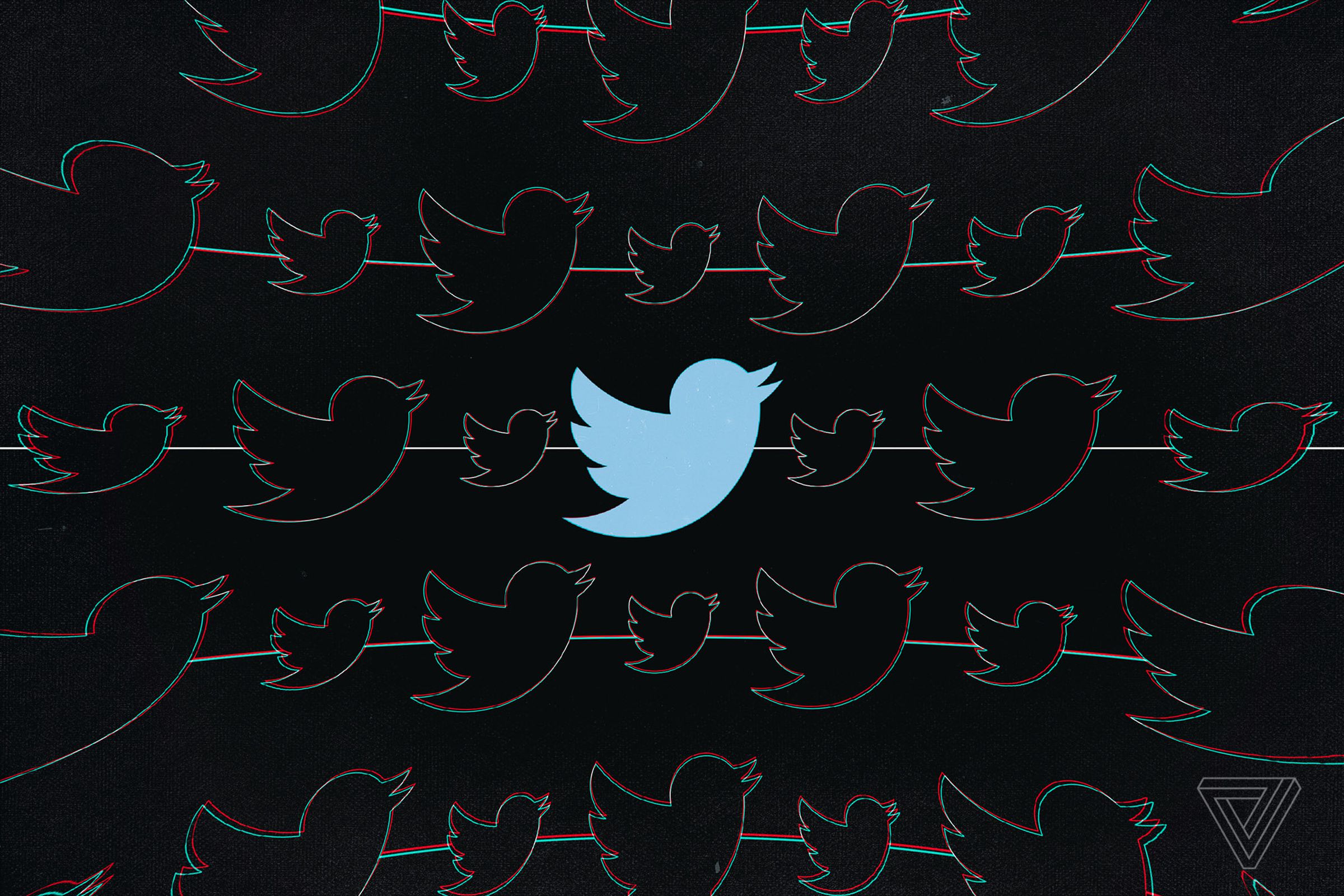 Twitter’s blue bird silhouette logo is seen on a black background.