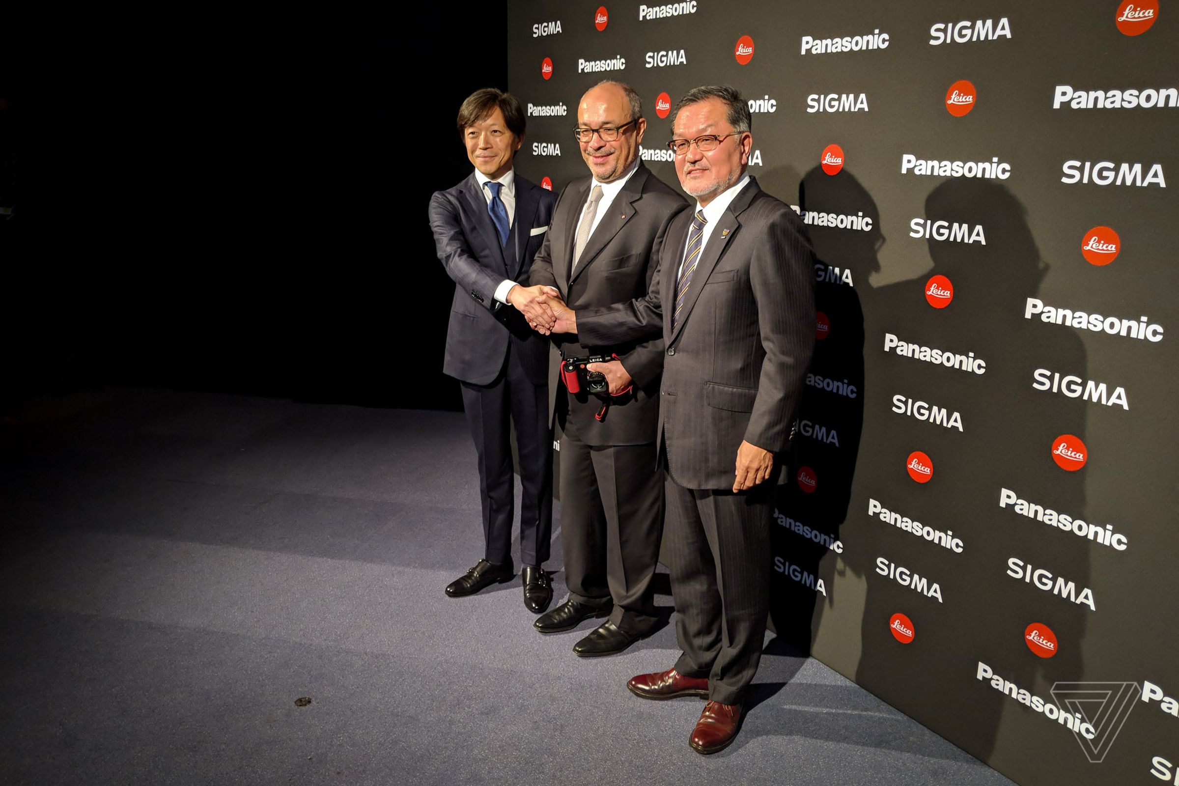 Sigma CEO Kazuto Yamaki, Leica chairman Andreas Kaufmann, and Panasonic VP Junichiro Kitagawa.