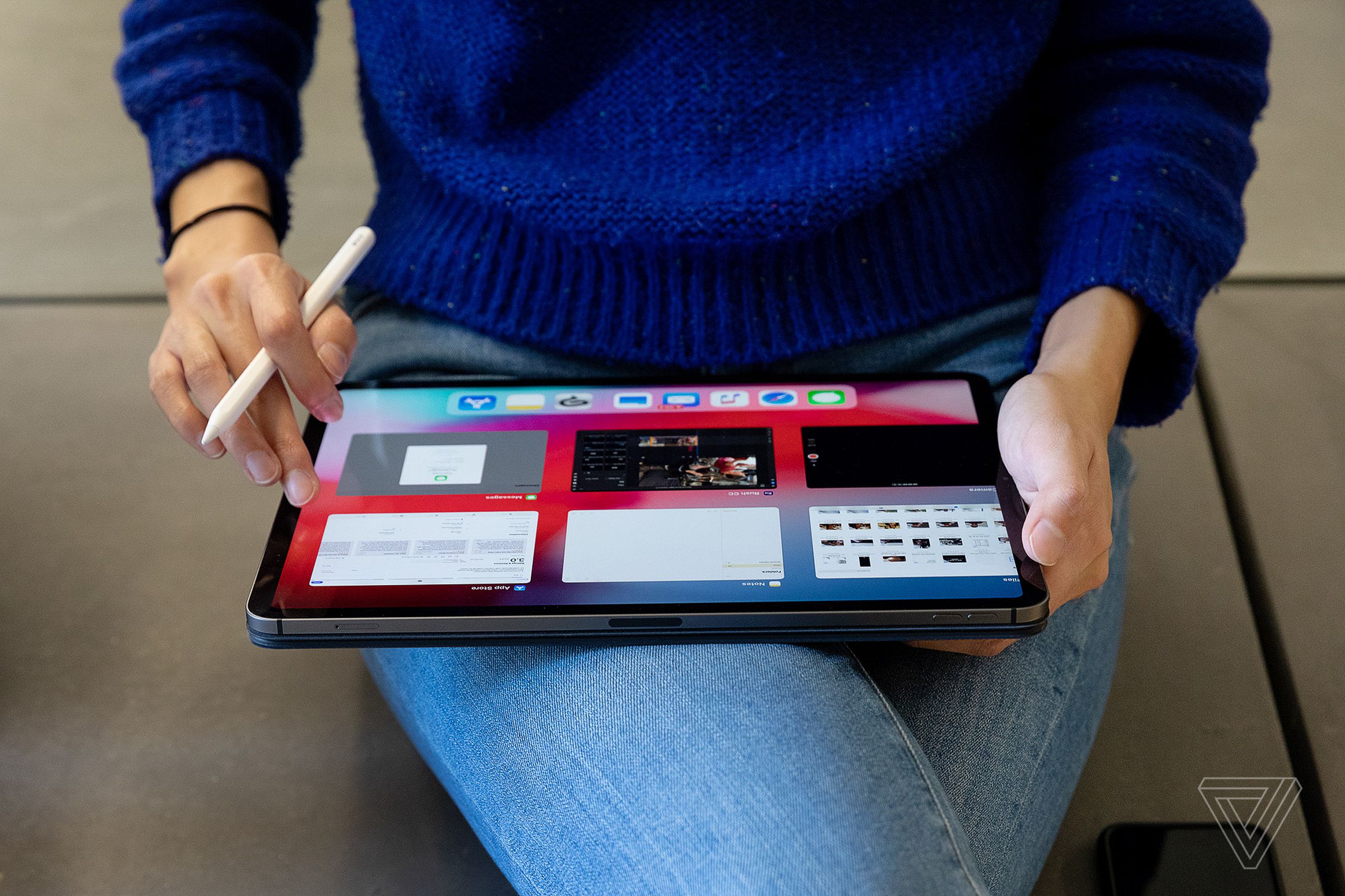 A person using an Apple Pencil on an iPad Pro tablet.
