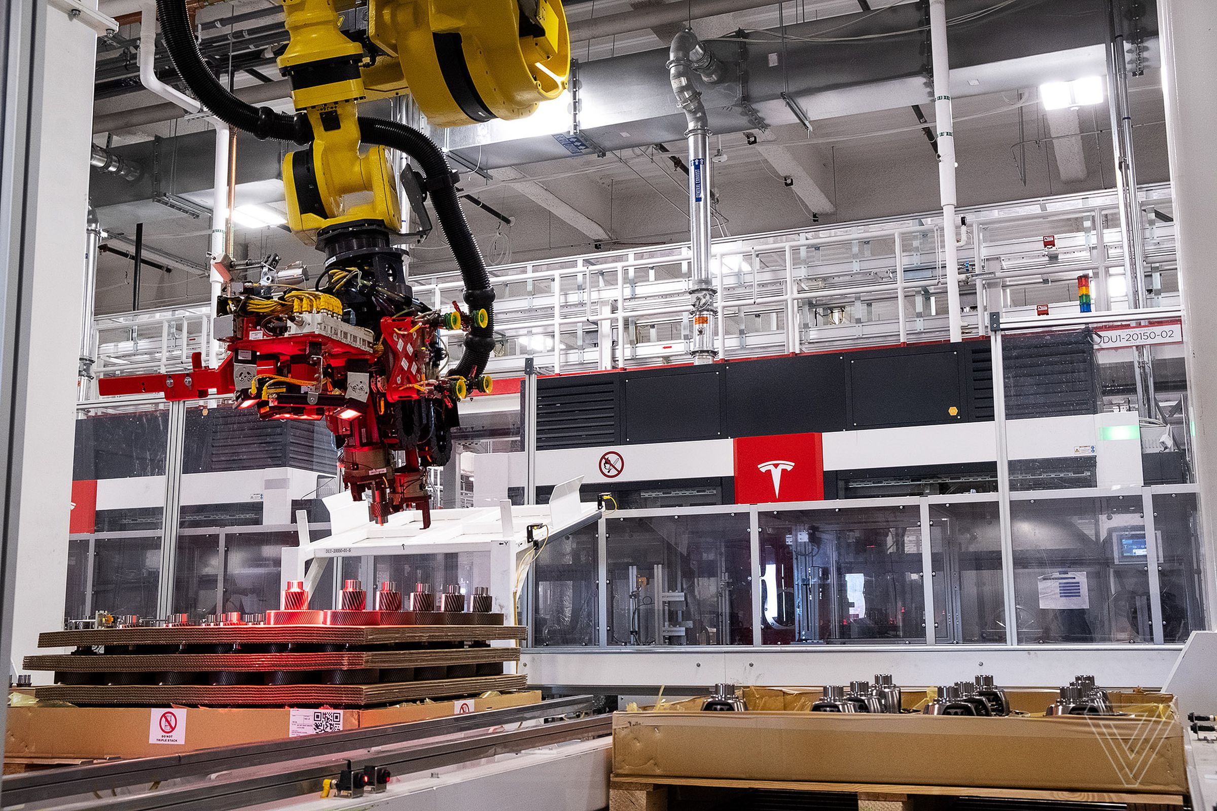 A robot picks parts at the Gigafactory.