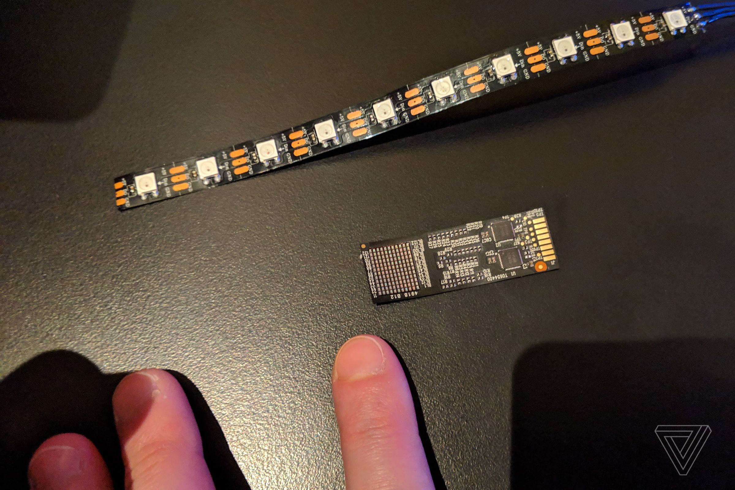 The standard RGB LED light strip, the Capellix array, and some human fingers for scale.