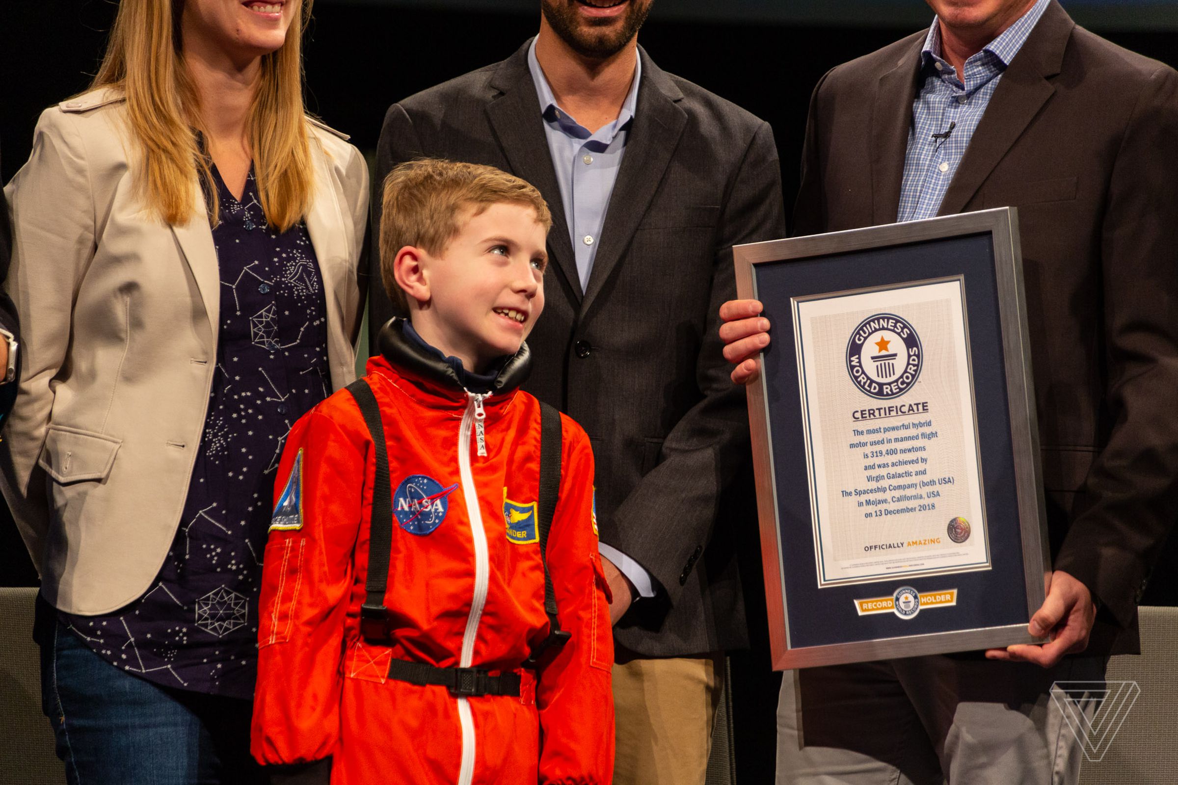 Branson invited a young boy in an astronaut suit to pose for pictures at the museum.