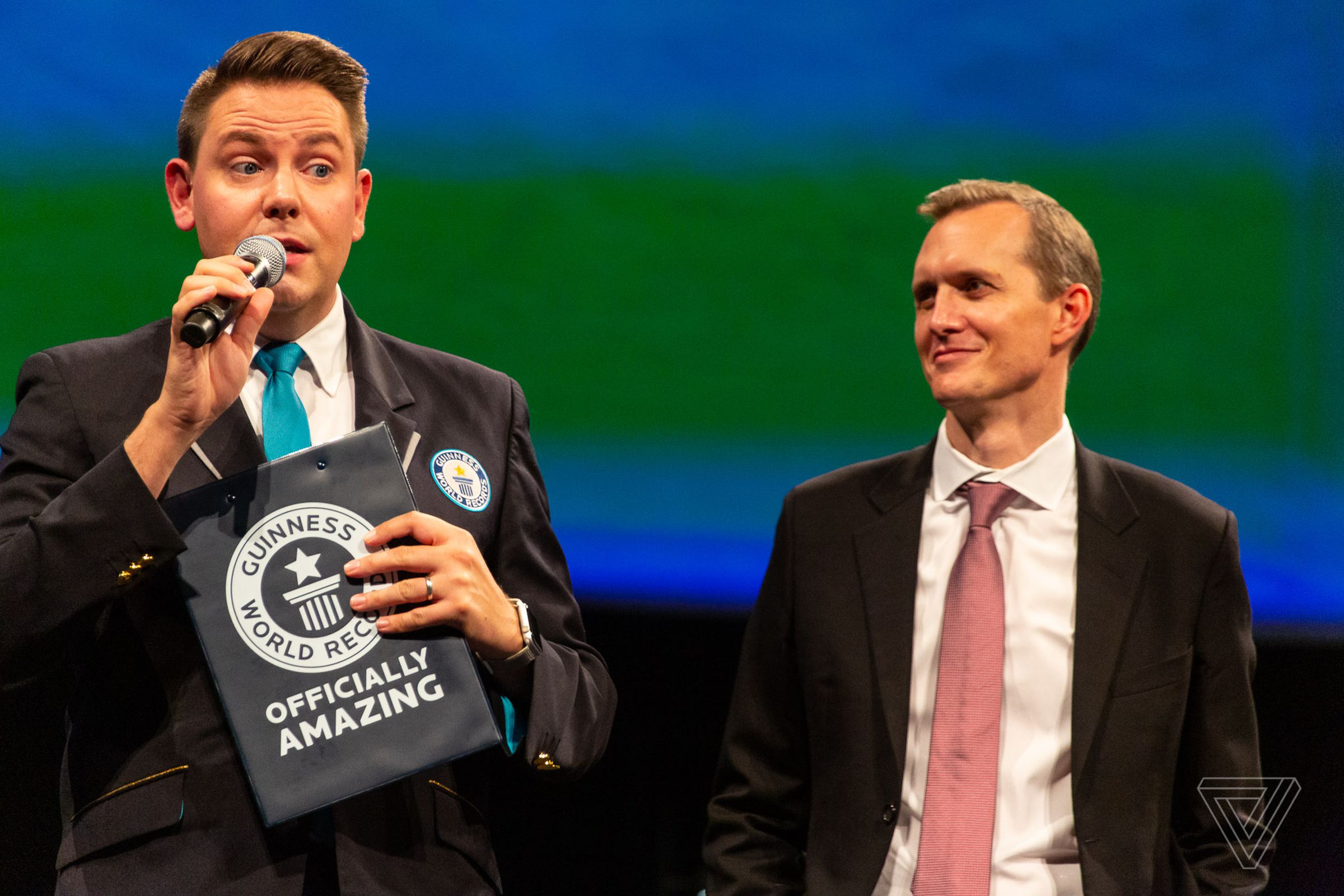 A representative for the Guinness World Records (left) presented a new award to Virgin Galactic CEO George Whitesides (right).