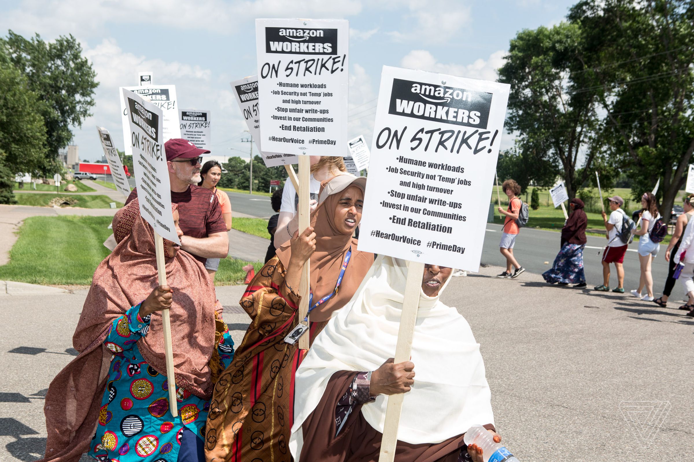Amazon workers, including Hibaq Mohamed (center), and their supporters protest outside of the Amazon Fulfillment Center on Prime Day in Shakopee, Minn.