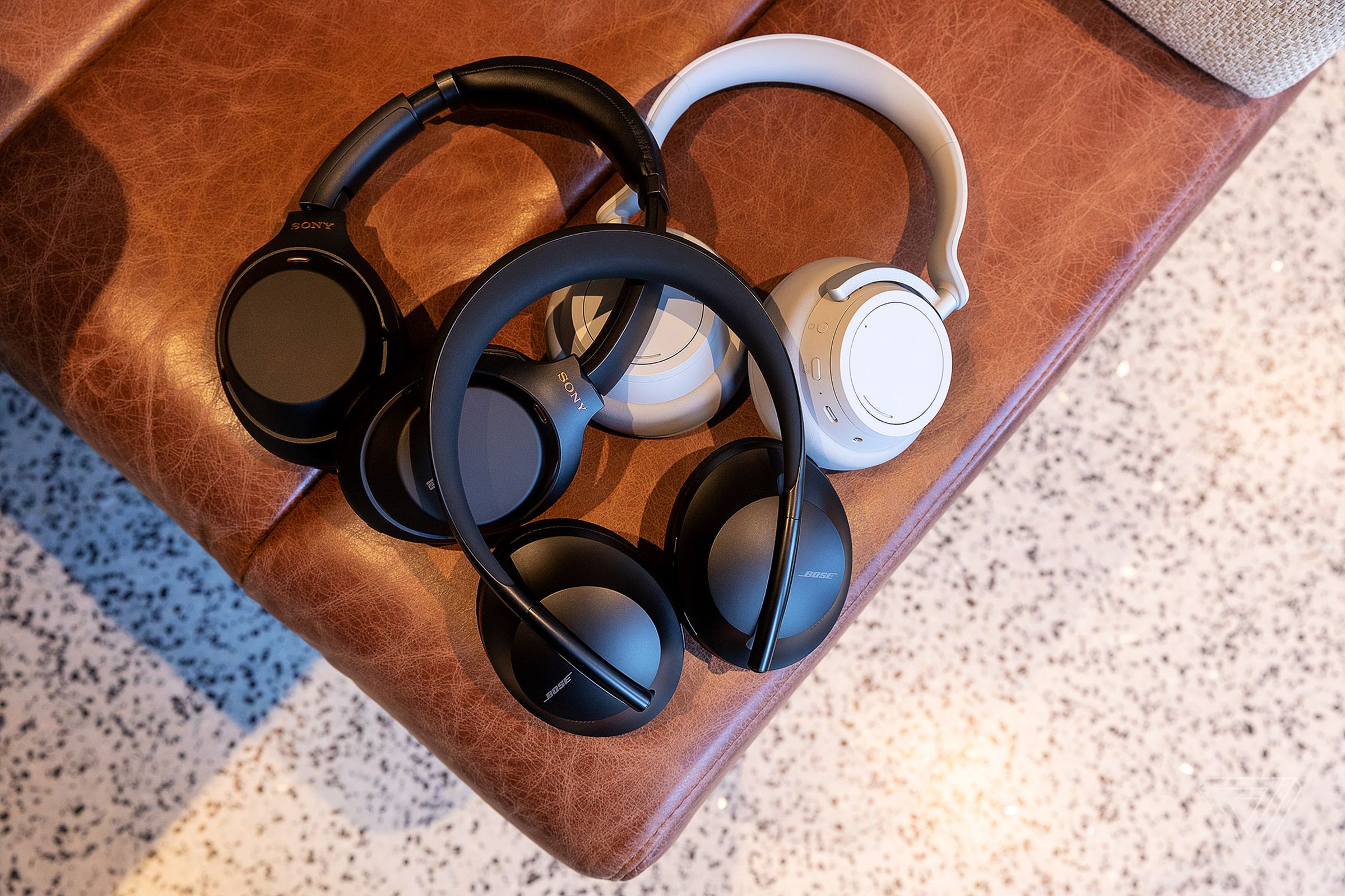 Bose’s Noise Cancelling Headphones 700 pictured with the Sony WH-1000XM3s and Microsoft’s Surface Headphones.