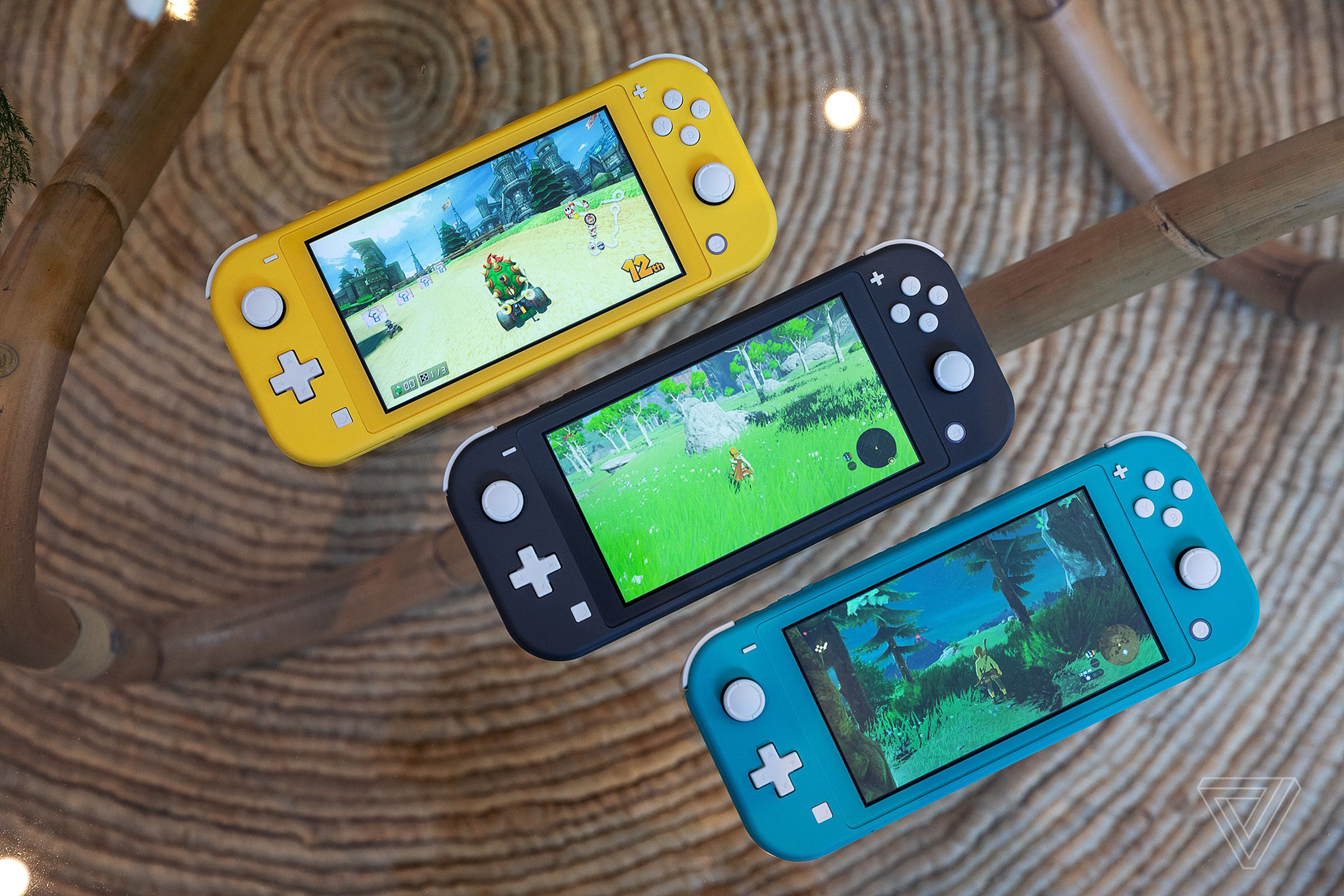 The handheld-only Nintendo Switch Lite in its yellow, gray, and turquoise colorways. 