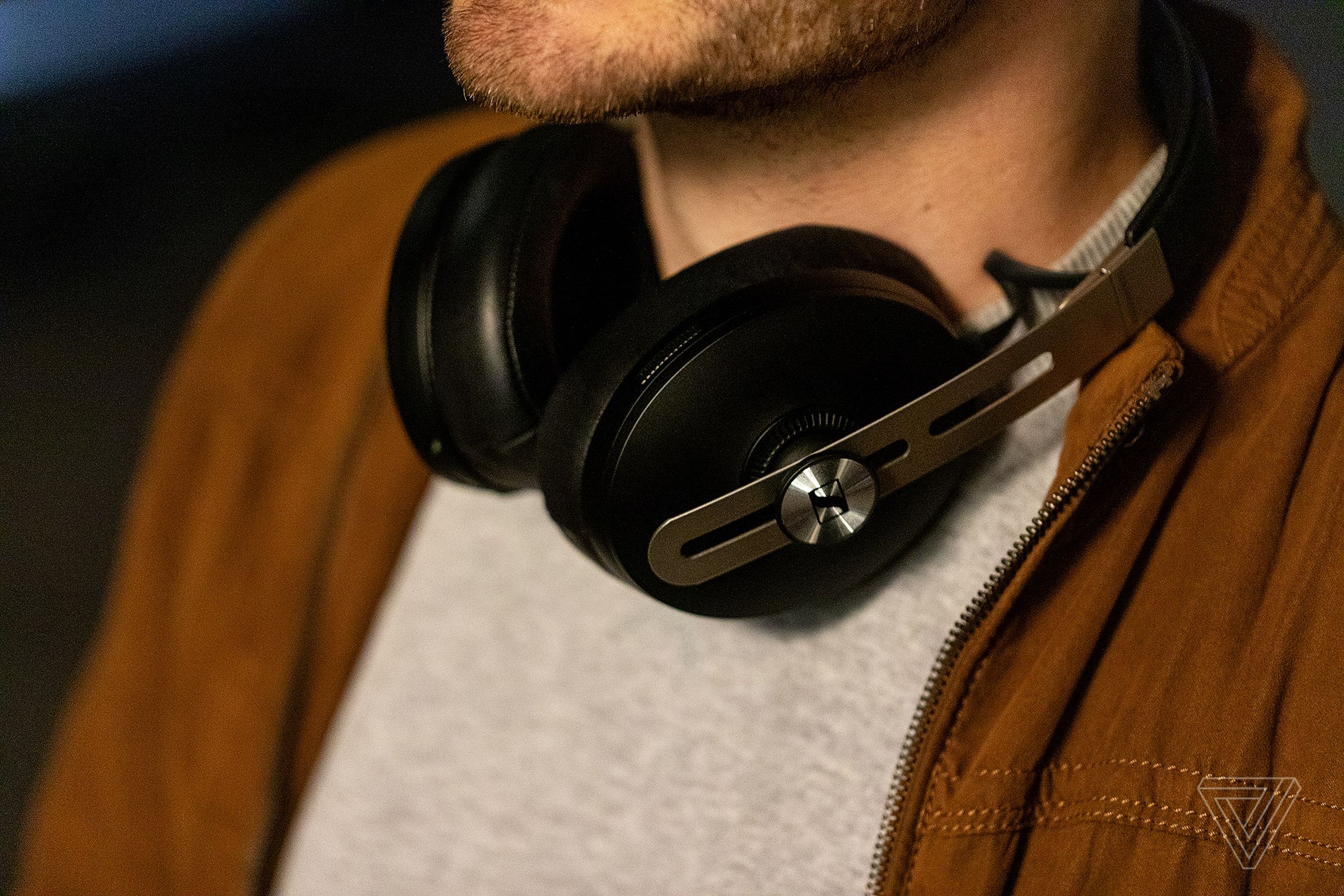 A photo of Sennheiser’s Momentum Wireless 3 headphones, previously our best noise-canceling headphones for sound quality, worn around someone’s neck.