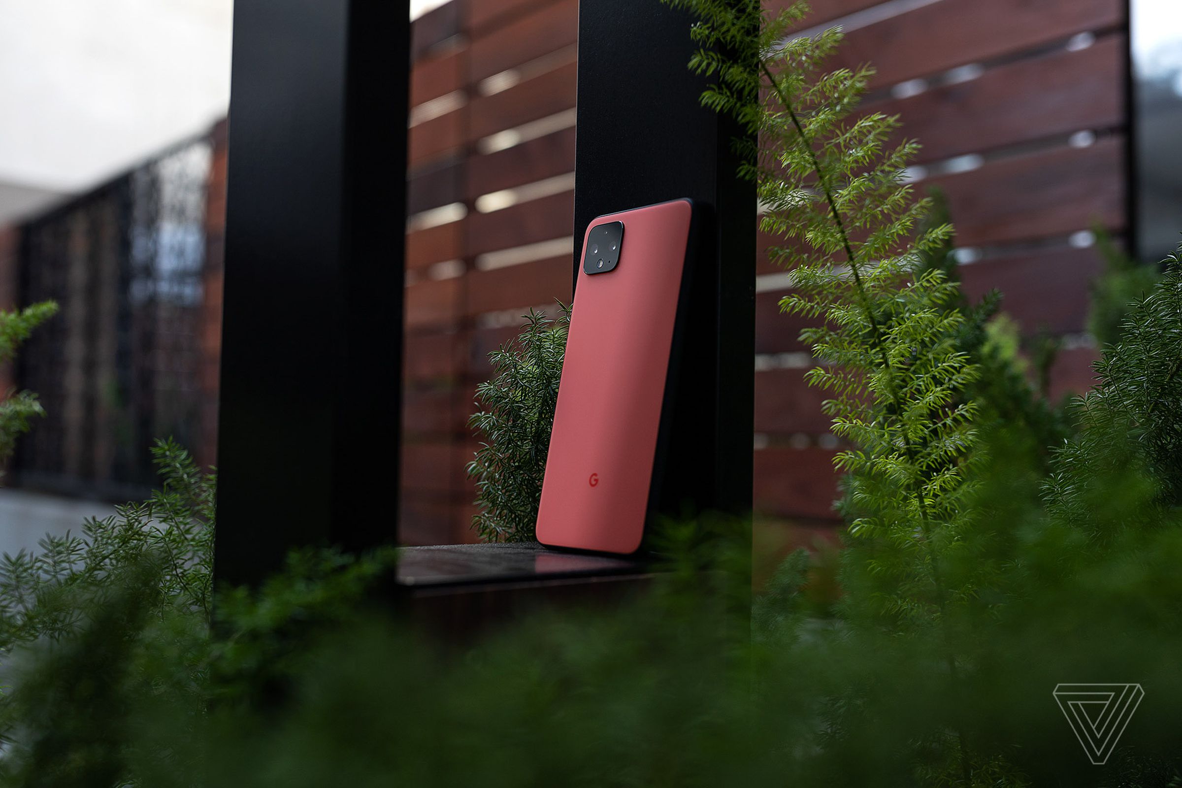 The Google Pixel 4 leaning against a small structure outdoors