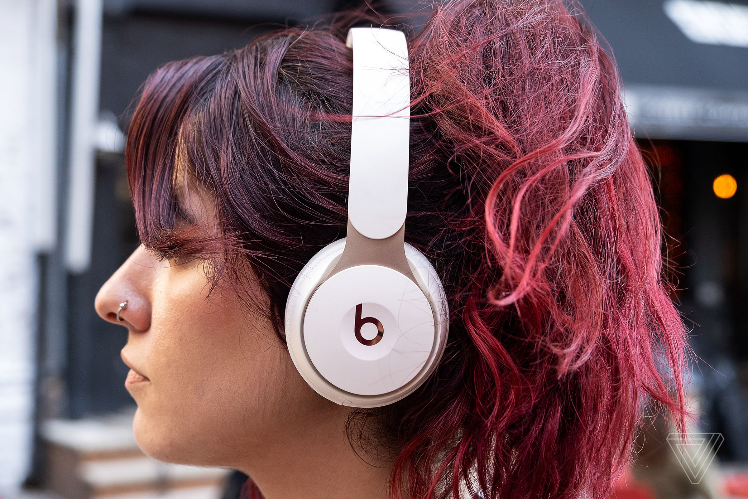 A woman wearing Beats Solo Pro headphones.