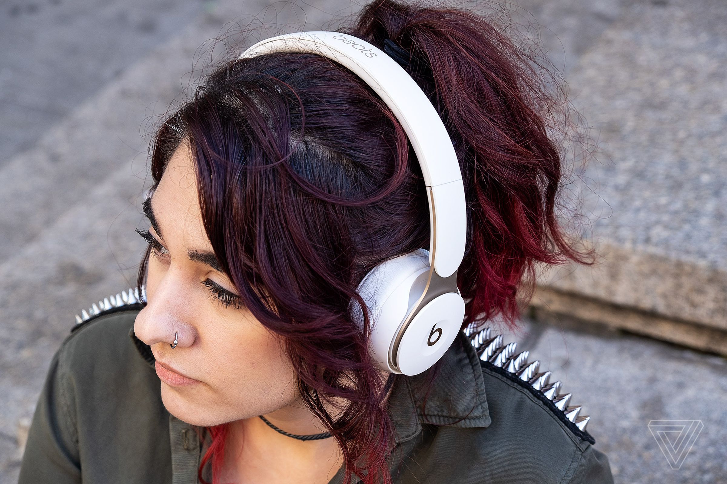 A photo of the Beats Solo Pro headphones, the best on-ear noise-canceling headphones, worn on a woman’s head.