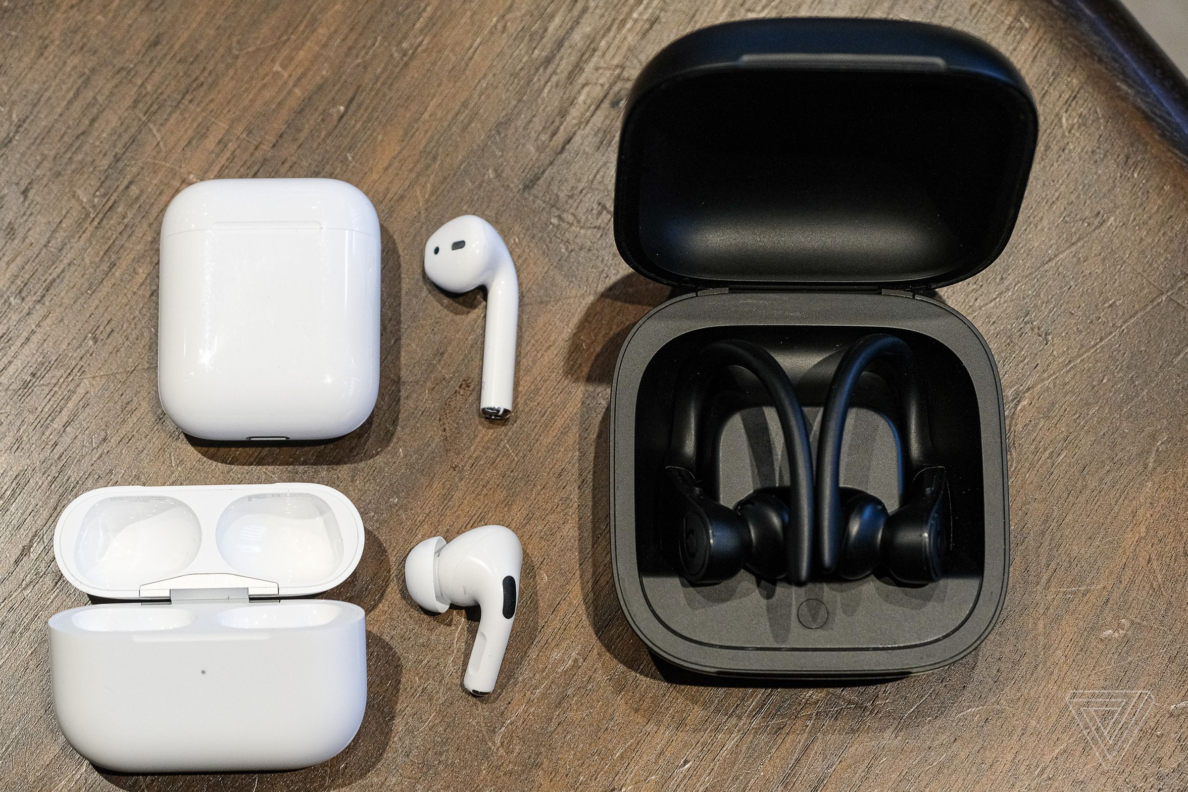 AirPods Pro at bottom left, with the previous AirPods above them and Powerbeats Pro to the right.