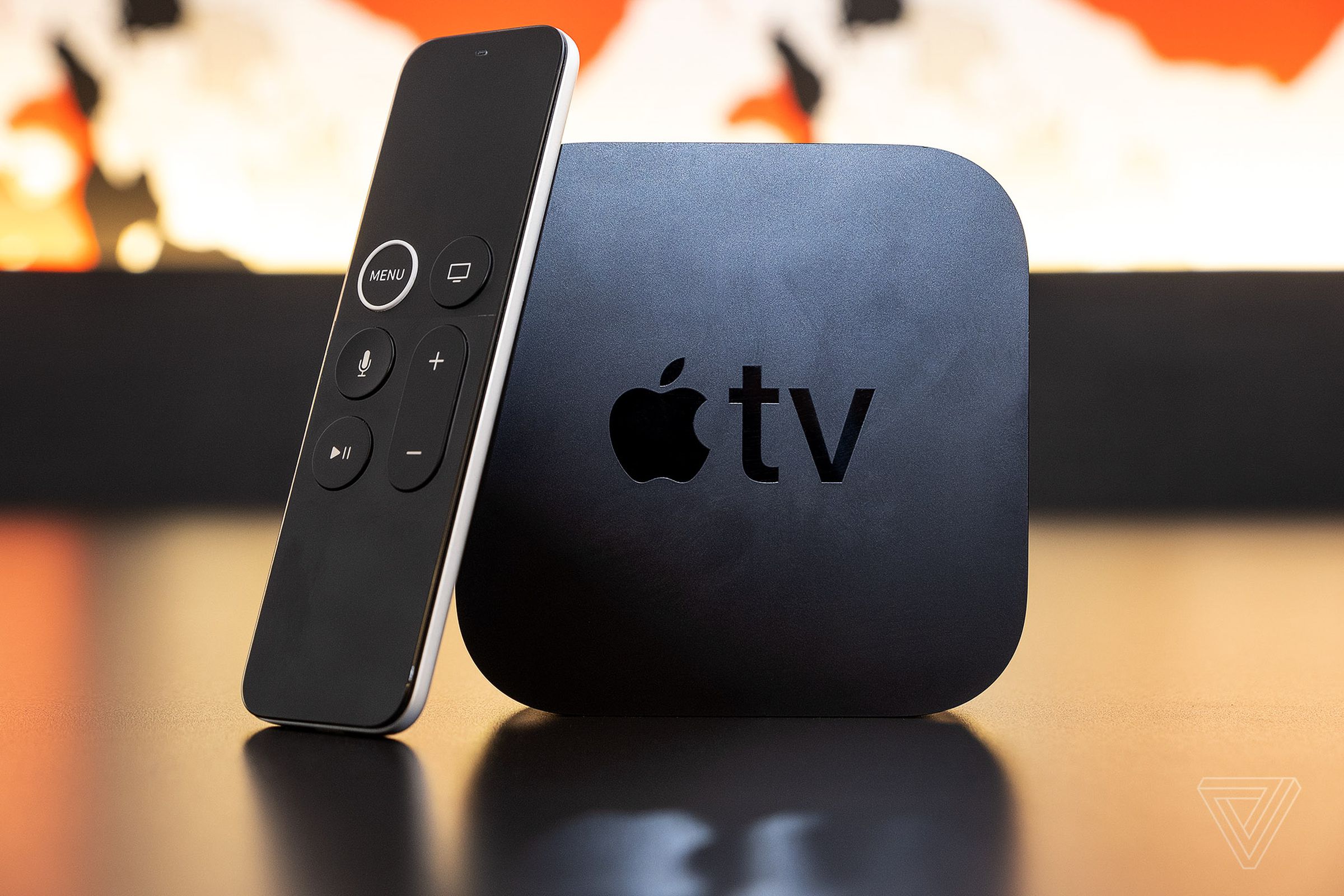 The Apple TV 4K, the best streaming device user experience, on a table with the Siri remote.