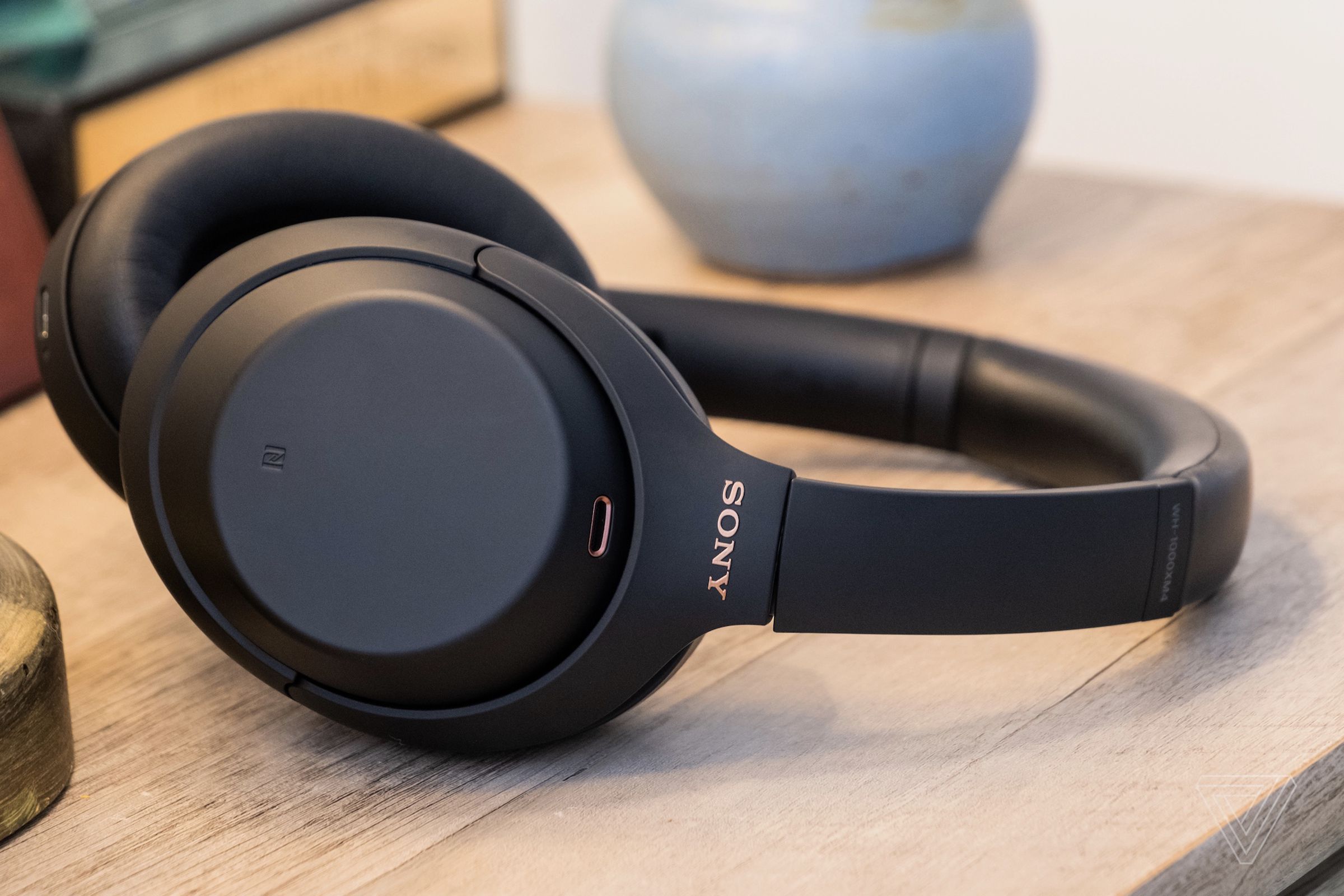 A photo of Sony’s WH-1000XM4, the best noise-canceling headphones for most people, resting on a table.