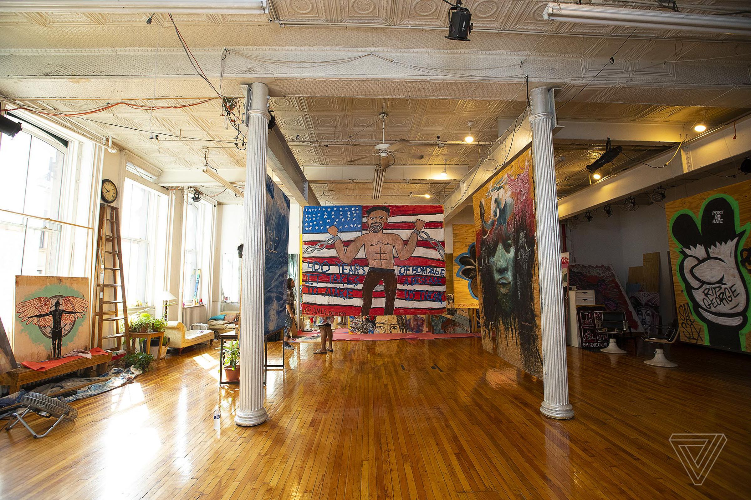 Amir Diop’s work that once boarded up the side of a business was hung inside the loft space.