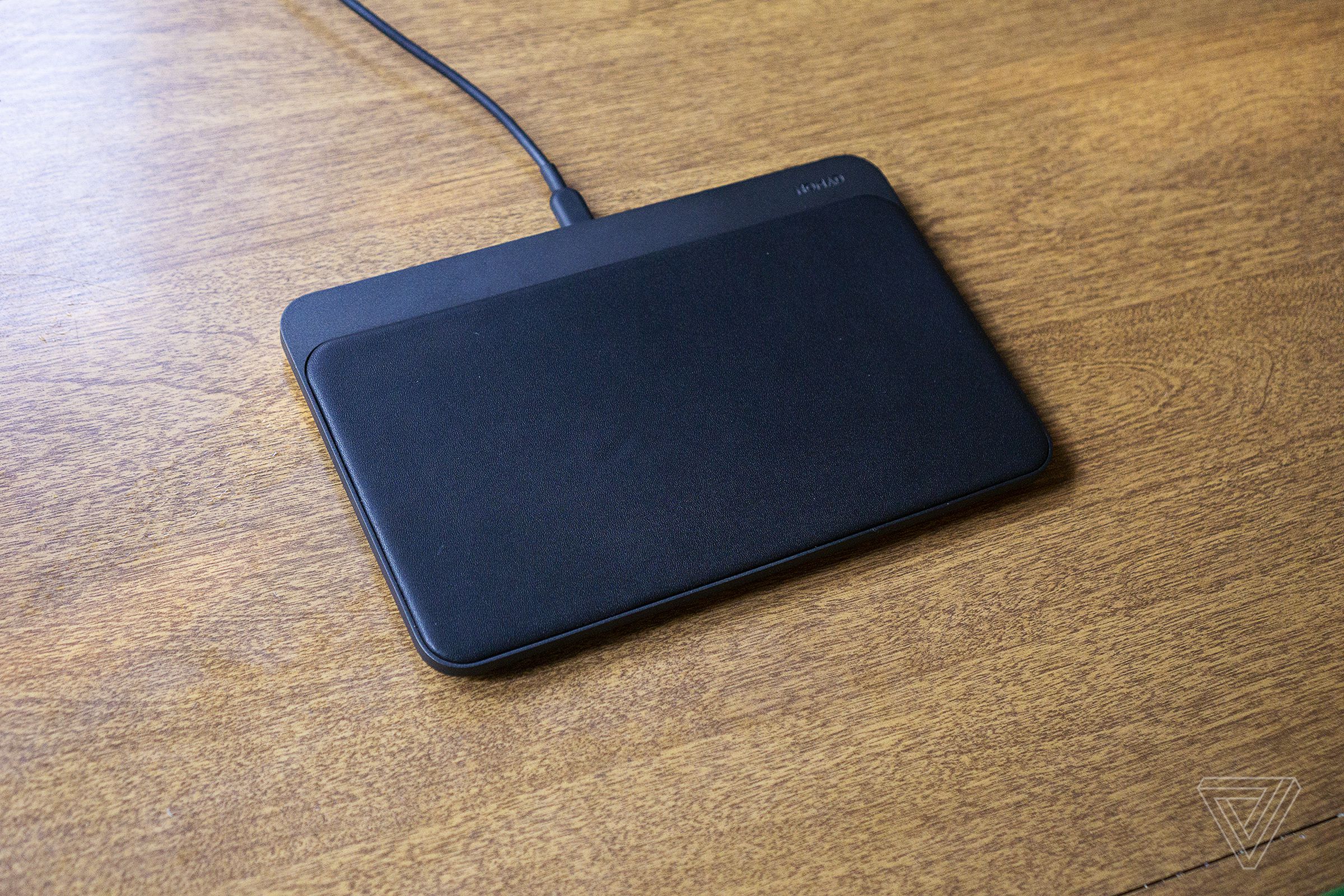 The leather and aluminum charger is unobtrusive on a nightstand or desk