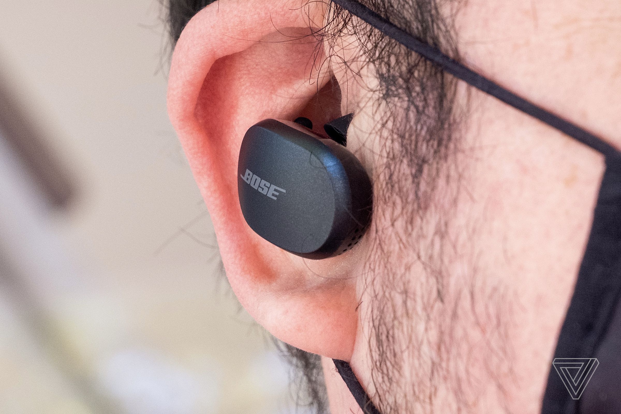 Bose’s QuietComfort Earbuds pictured worn in a person’s right ear.