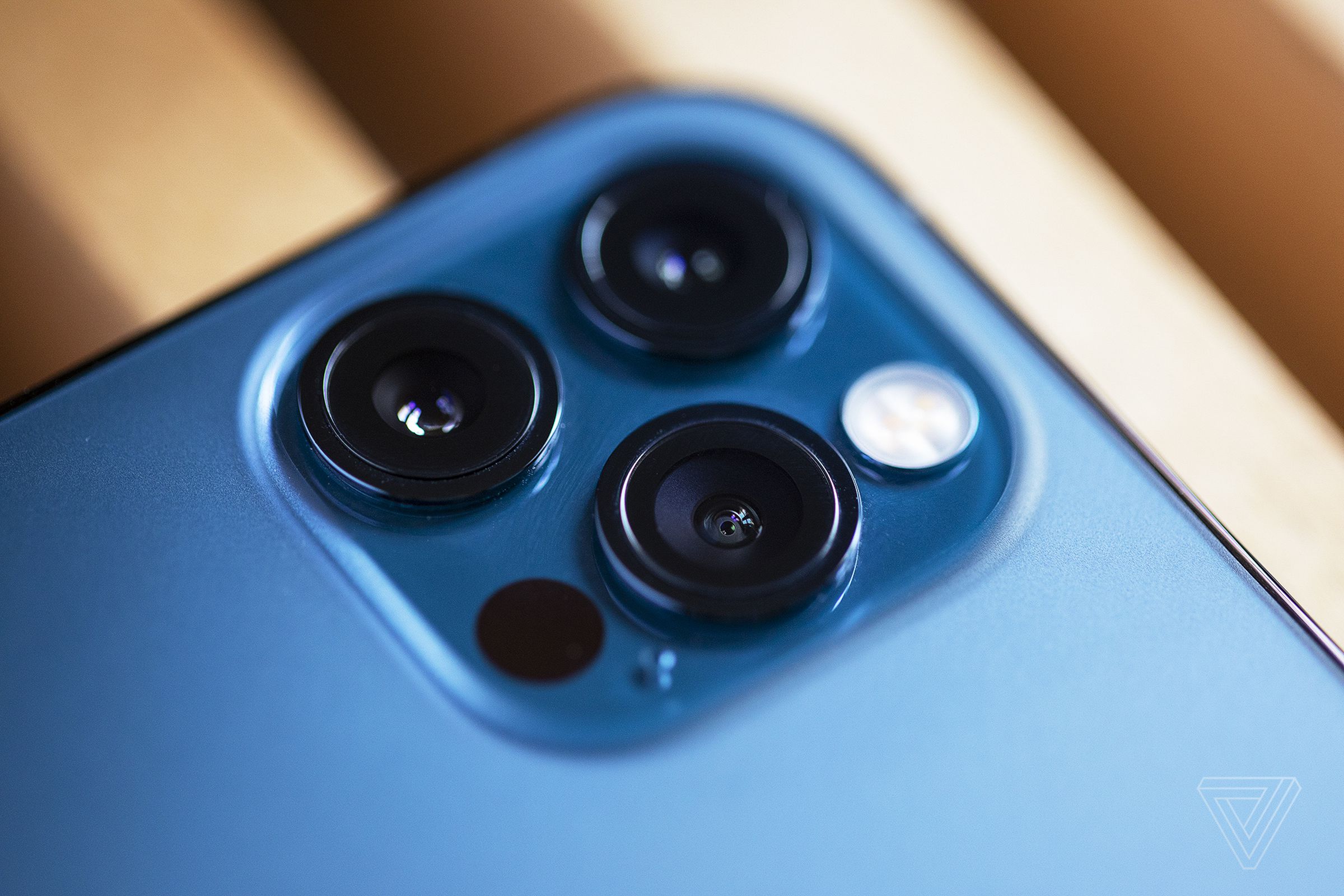 The iPhone 12 Pro has three cameras — normal, ultrawide, and telephoto — plus a LIDAR sensor on the back.