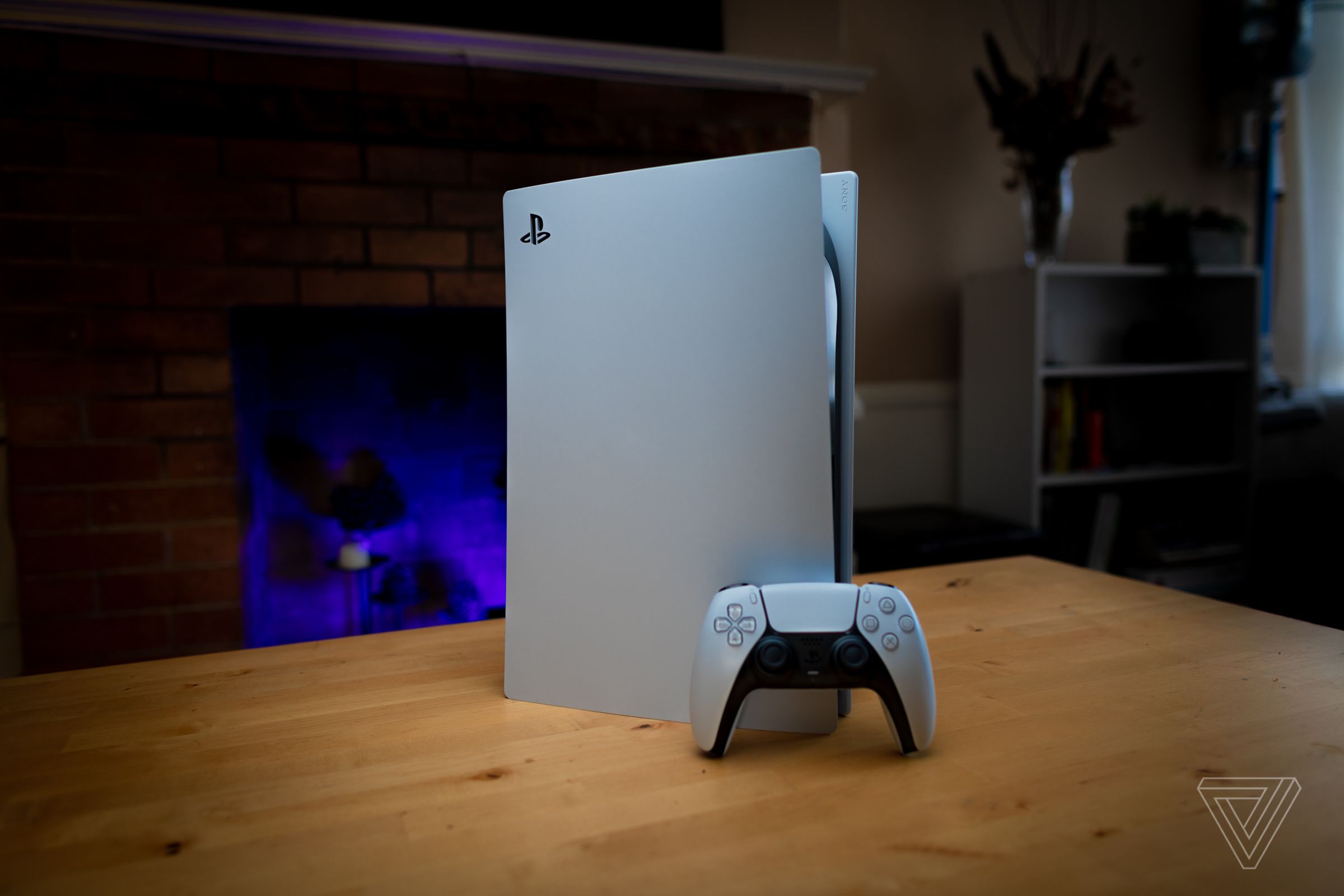 A PS5 console on a wooden table.