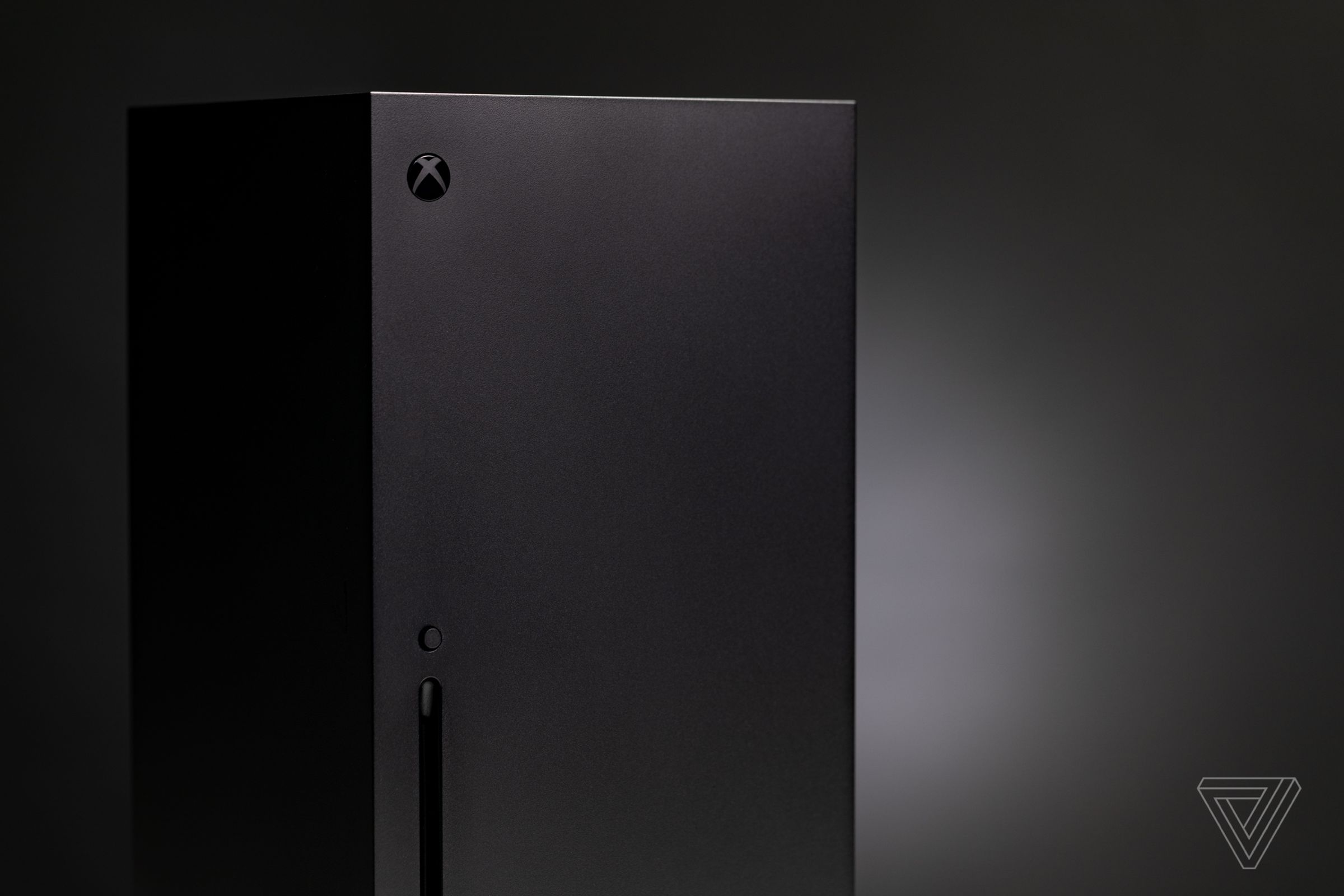The Xbox Series X in front of a black background.