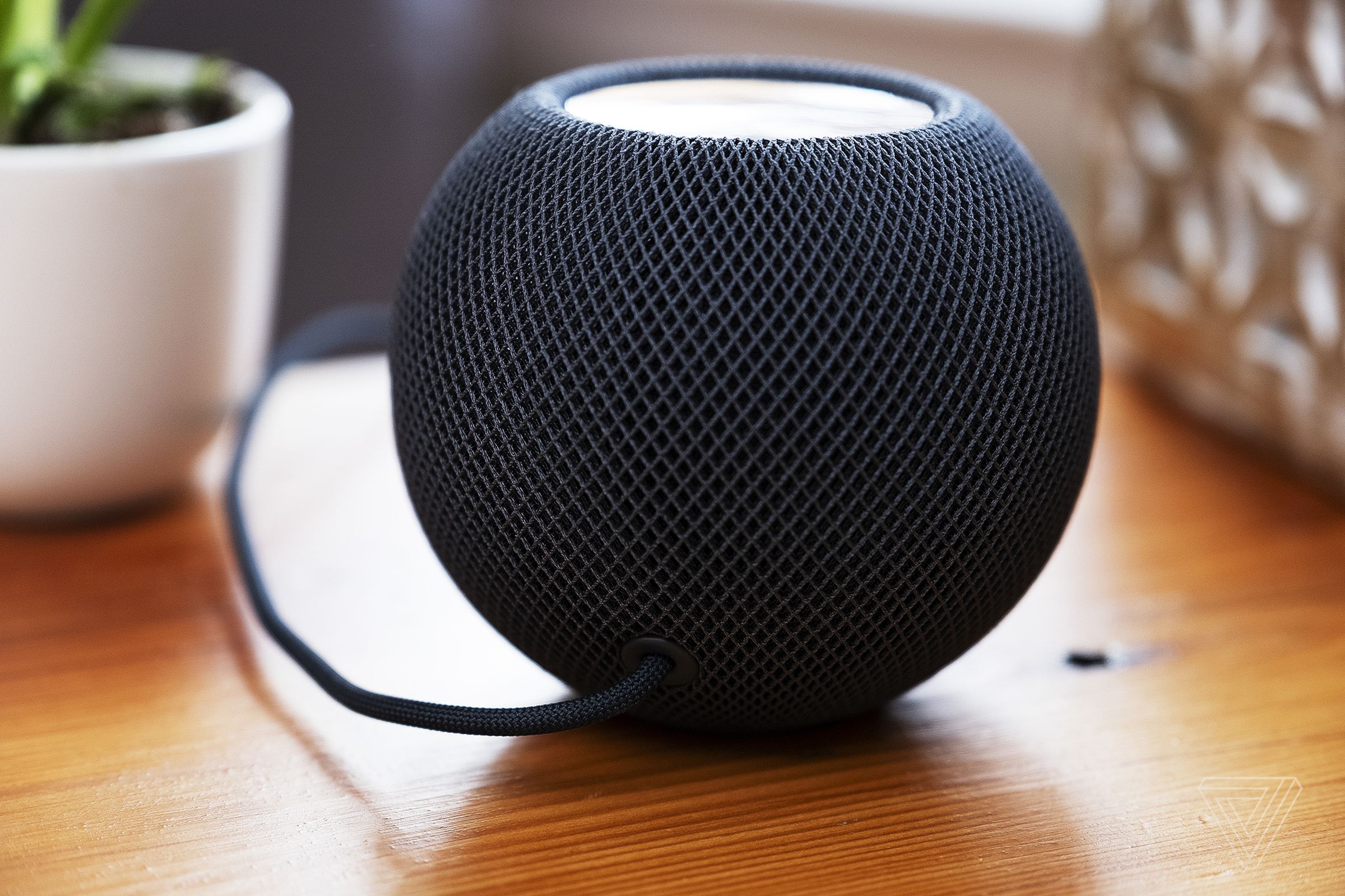 The USB-C power cable is permanently attached to the HomePod mini.