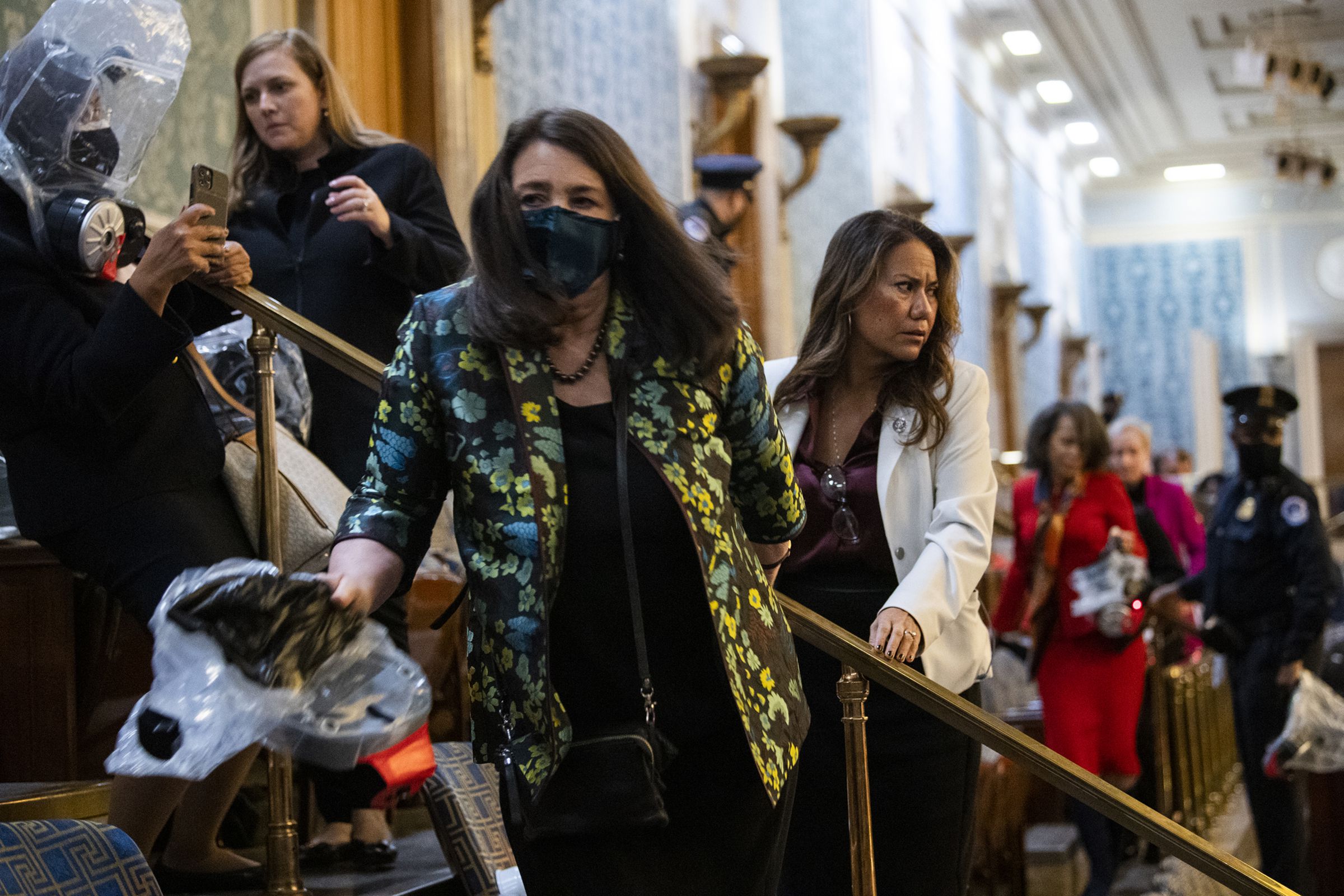 Reps. Diana DeGette (D-CO) and Veronica Escobar (D-TX) are directed toward exits by Capitol Police.