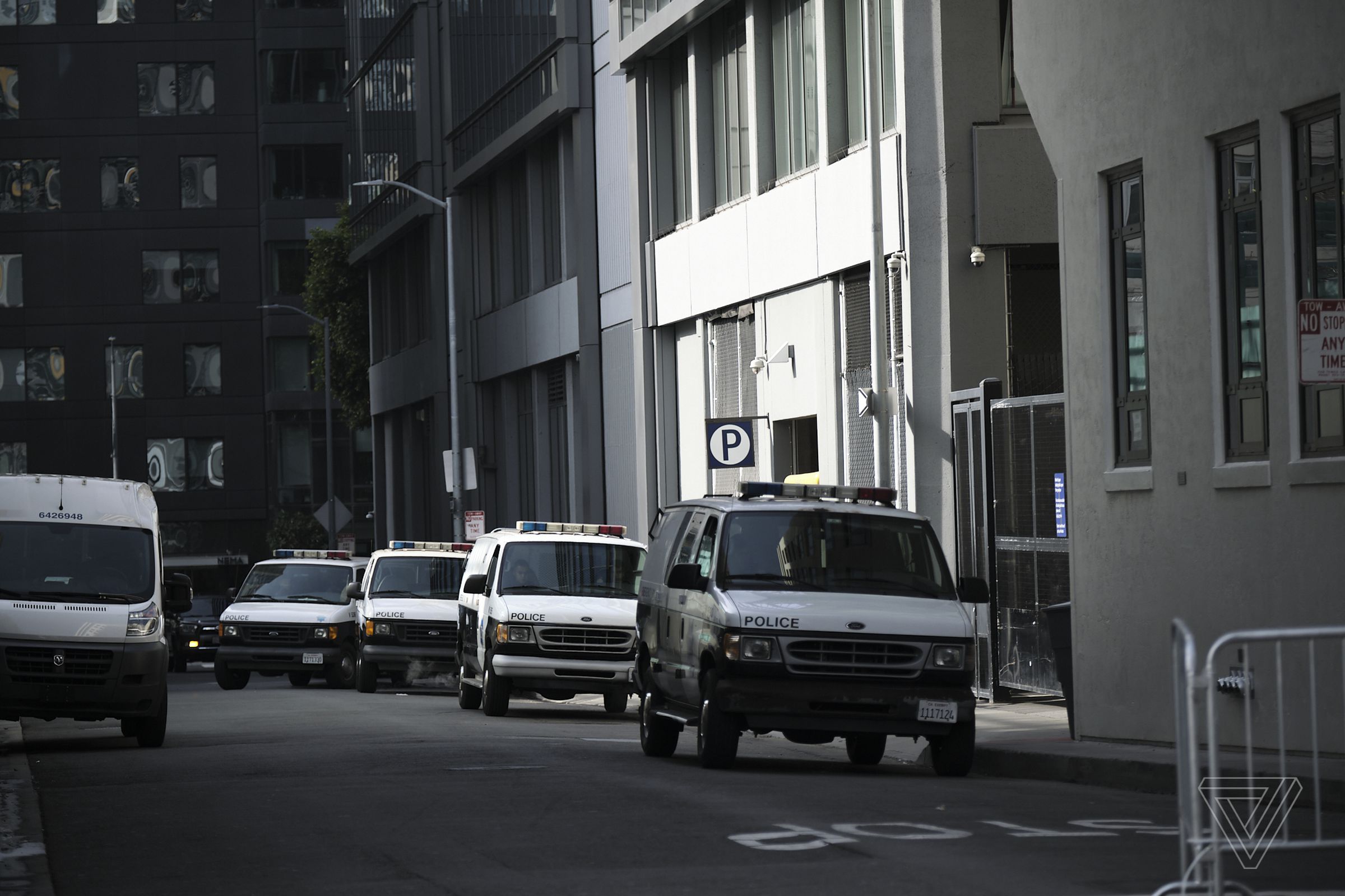 Police vans parked in the alley behind the Twitter headquarters.