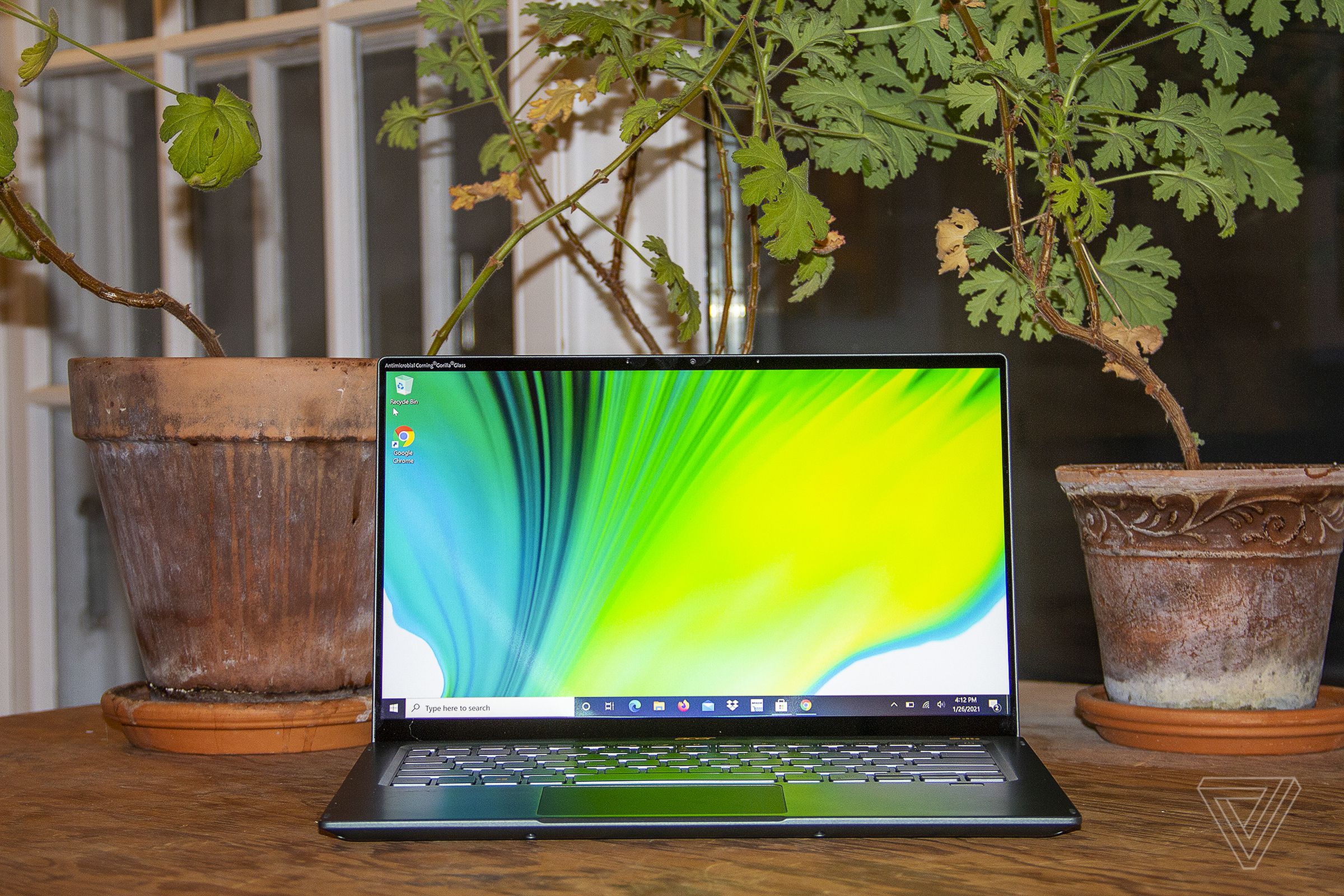 The Acer Swift 5 open, seen from the front. The screen depicts a green, blue, and white background.