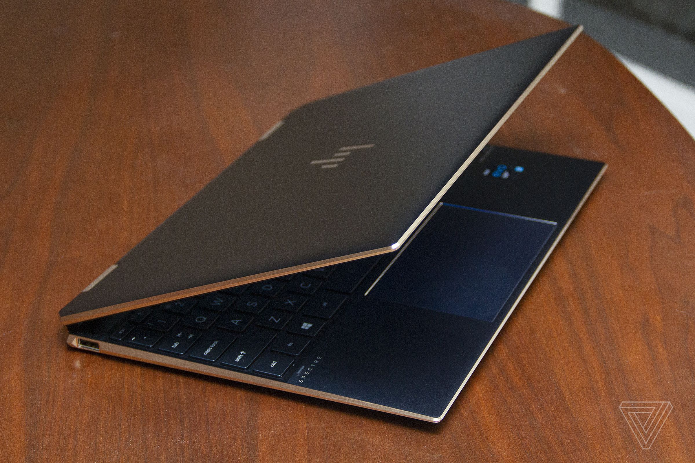 The HP Spectre x360 angled to the right, seen from above, with the lid half closed.