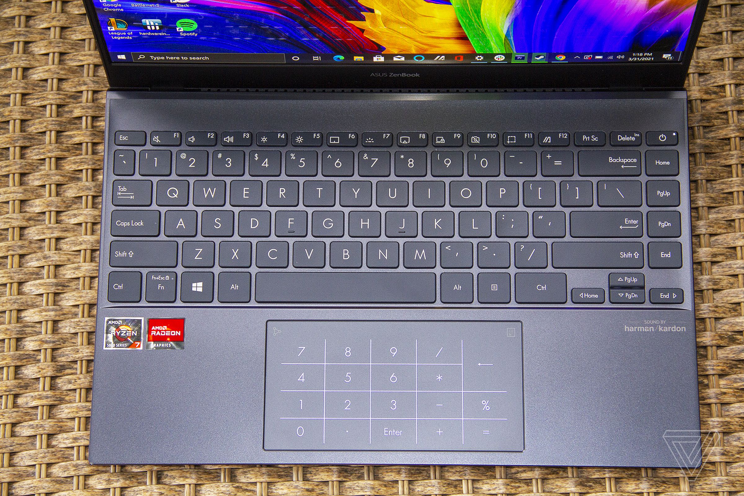 The Asus Zenbook 13 OLED keyboard seen from above. The screen displays an LED numpad.