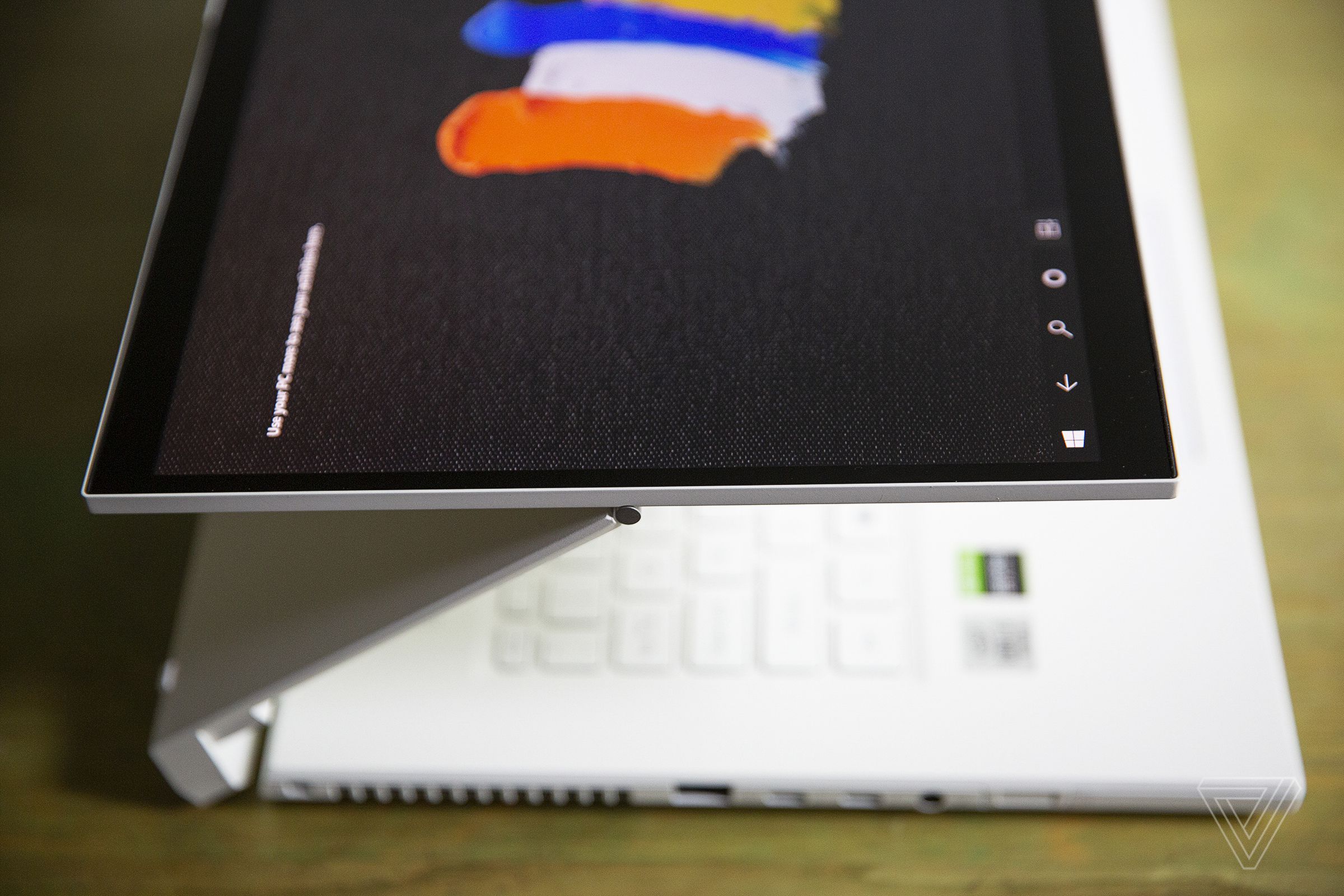 The Acer ConceptD 7 Ezel in Float, seen from above and to the left. The screen displays several paintbrush strokes on a black background.